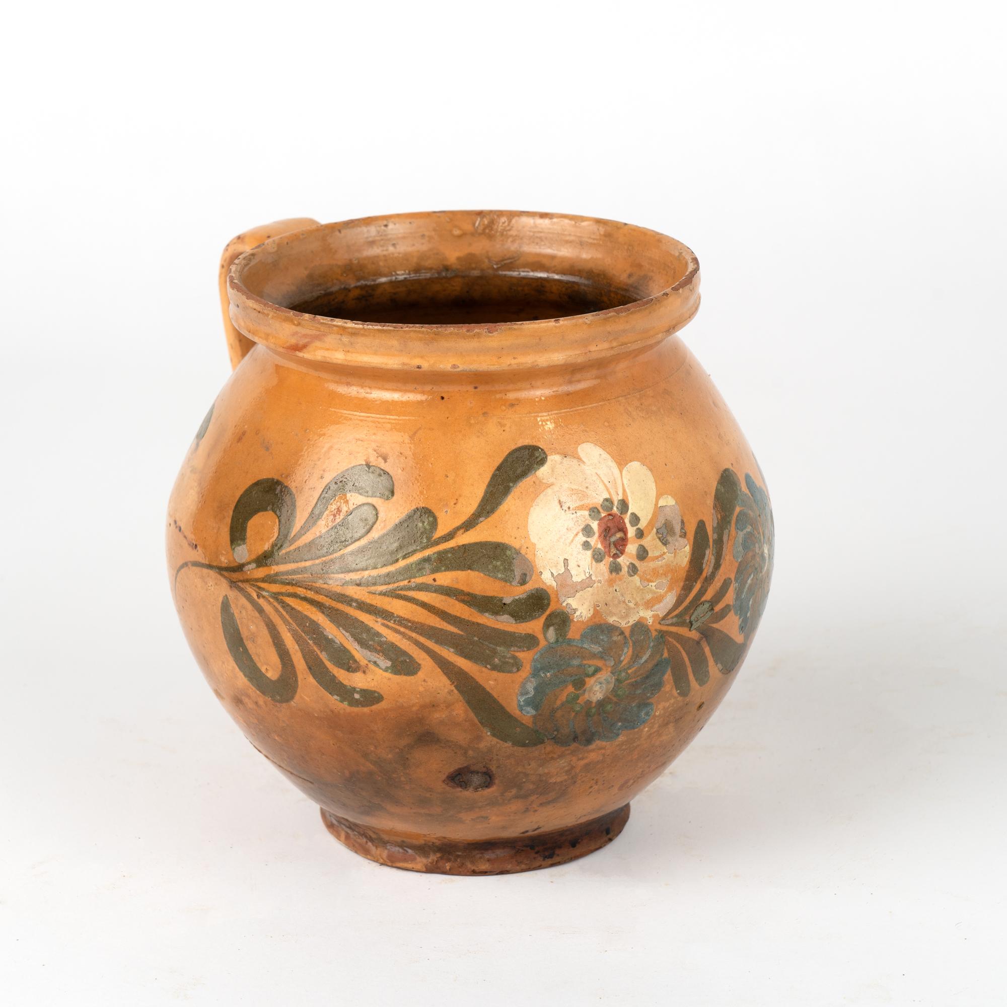 Original hand painted earthenware pottery with handle. Terracotta background with floral and leaf/vine pattern.
Sold in original vintage used condition. Any chips, cracks, stains, distress to paint or pottery is reflective of age and use. Solid