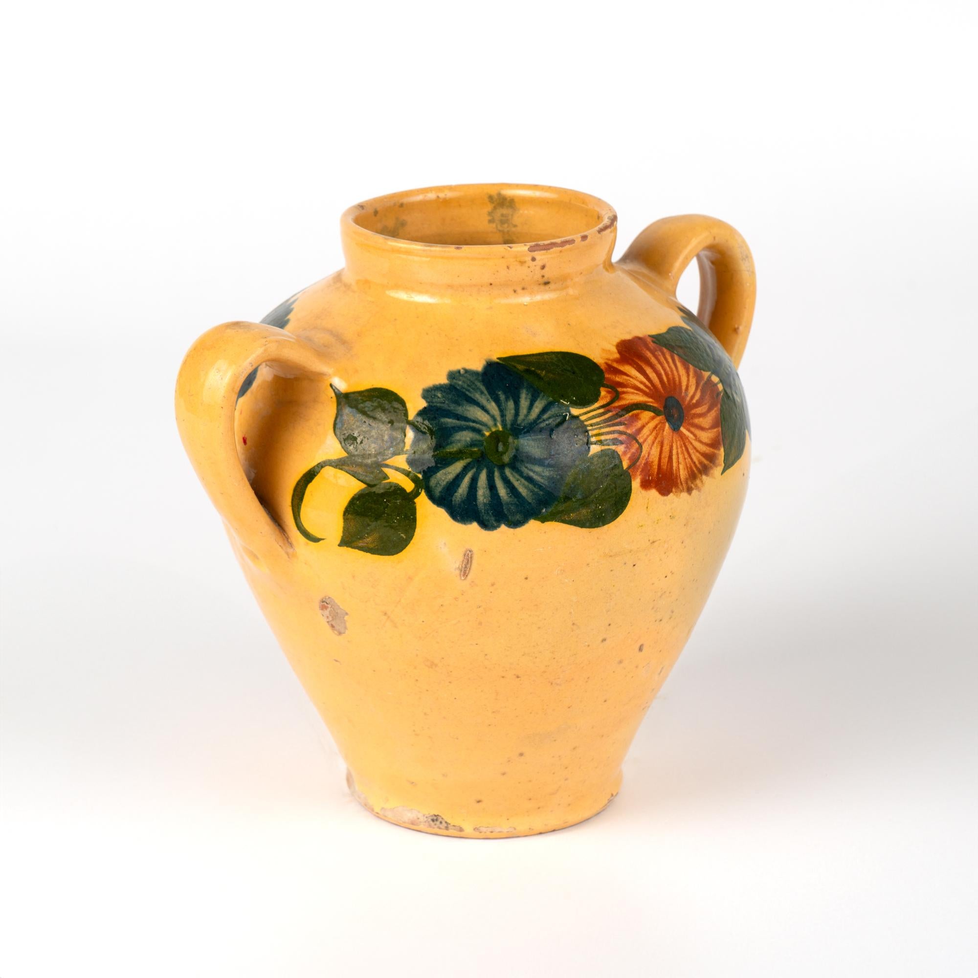 Original hand painted earthenware pottery with two handles. Yellow background with floral design.
Sold in original vintage used condition. Any chips, cracks, stains, distress to paint or pottery is reflective of age and use. Solid condition.

With