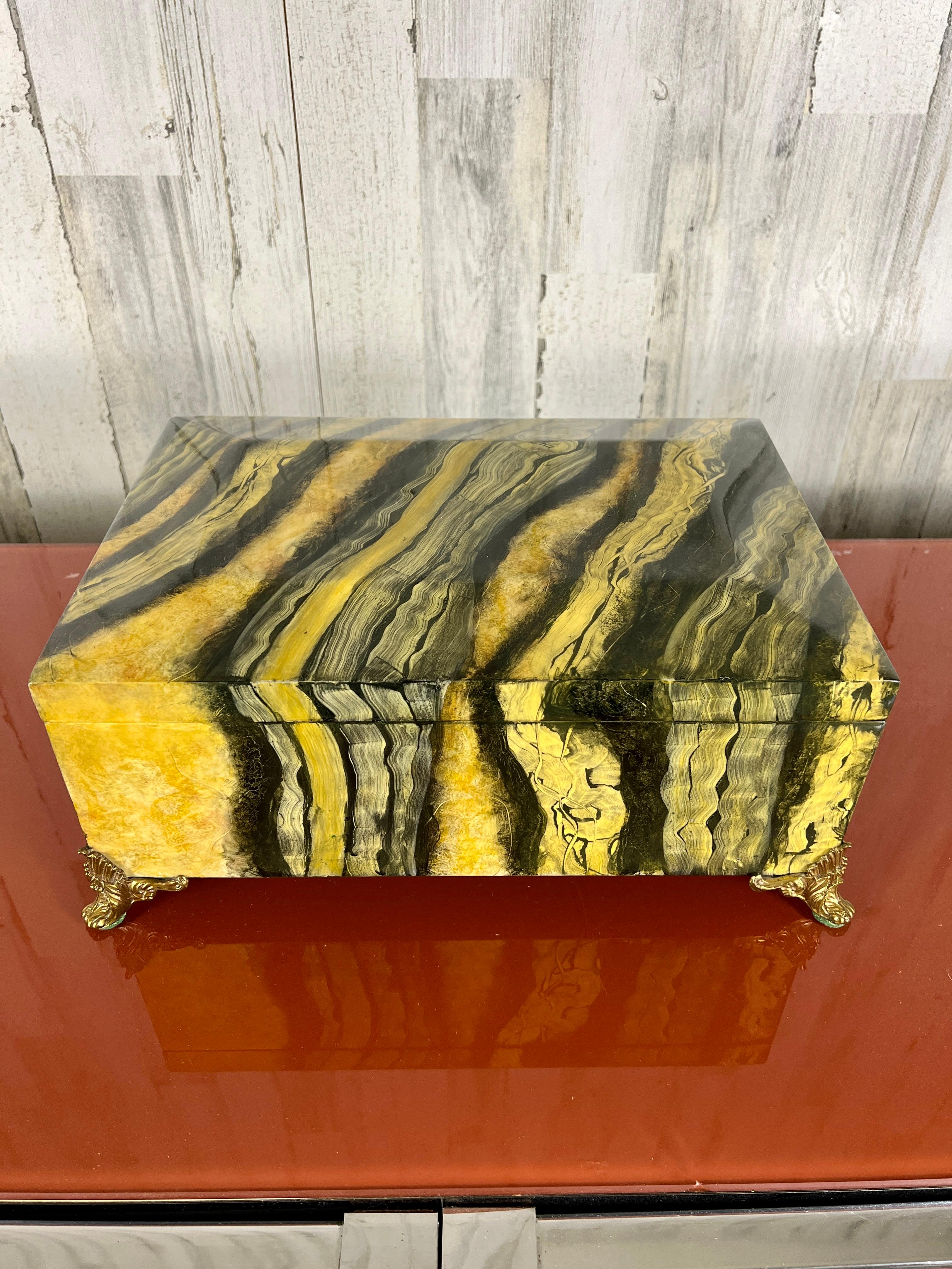 Hand painted Faux onyx Maitland Smith decorative box with hinged lid and brass feet. Wonderful brush work make this quite the decorative item to add to your space.