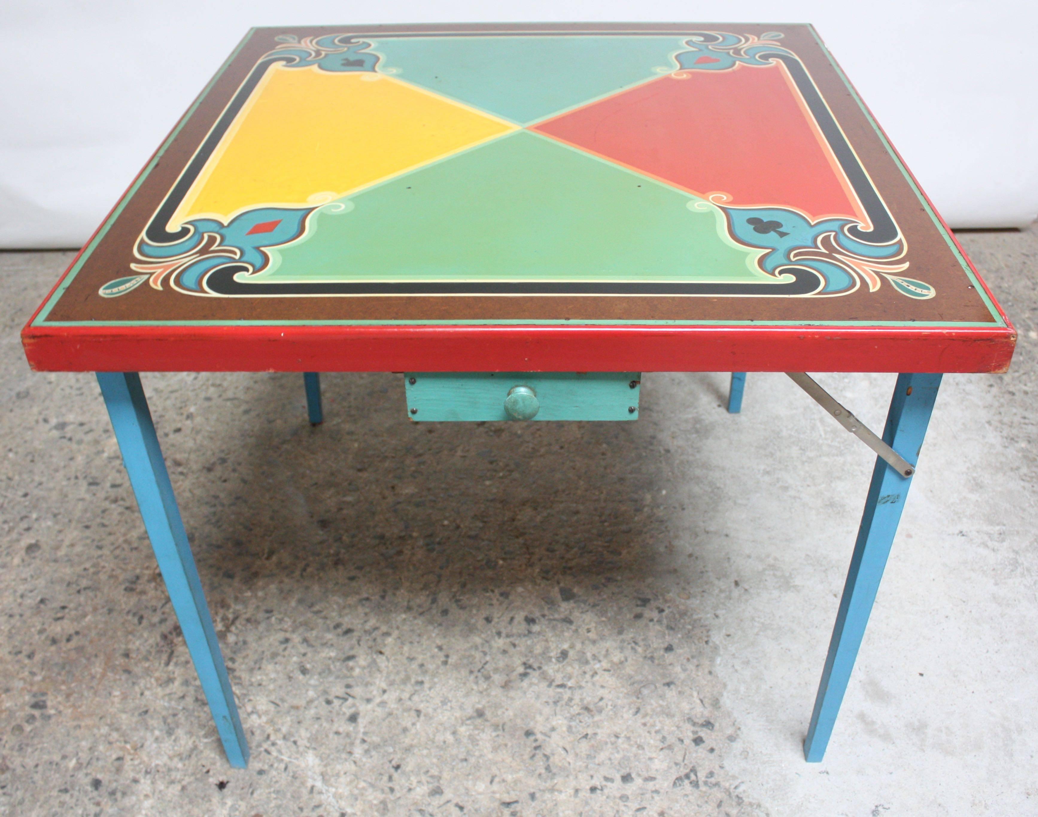 Charming, hand-painted card table displaying all four card suits with a small double sided drawer. Legs are collapsible for easy storage.
Retains all original paint shows wear from use including spotting and loss in places. Nice patina and age.