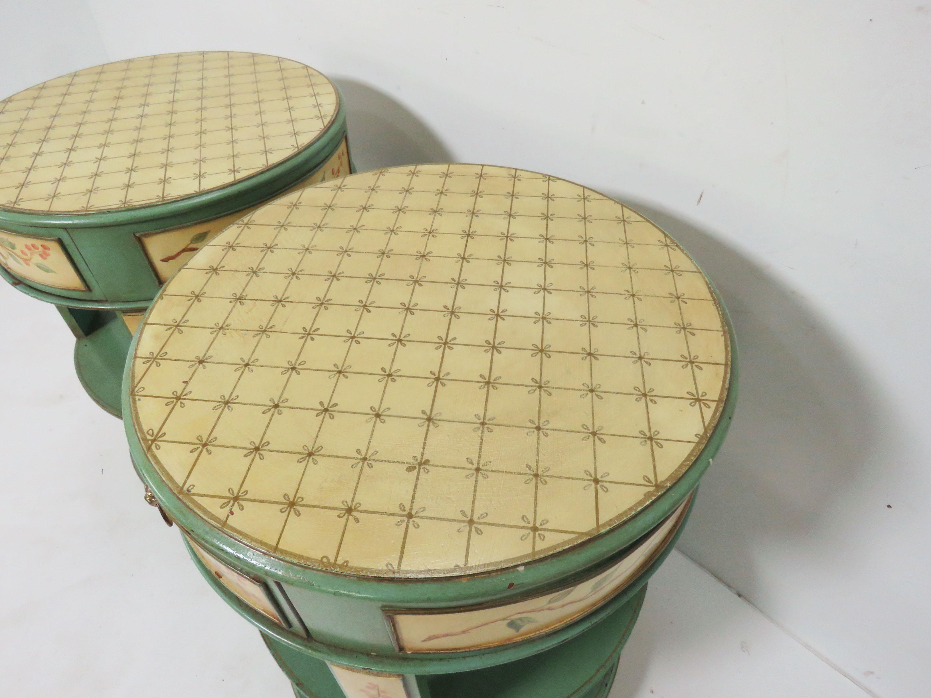 A pair of French country drum side tables, hand painted in the Provençal manner and well suited as bedside stands or side tables.