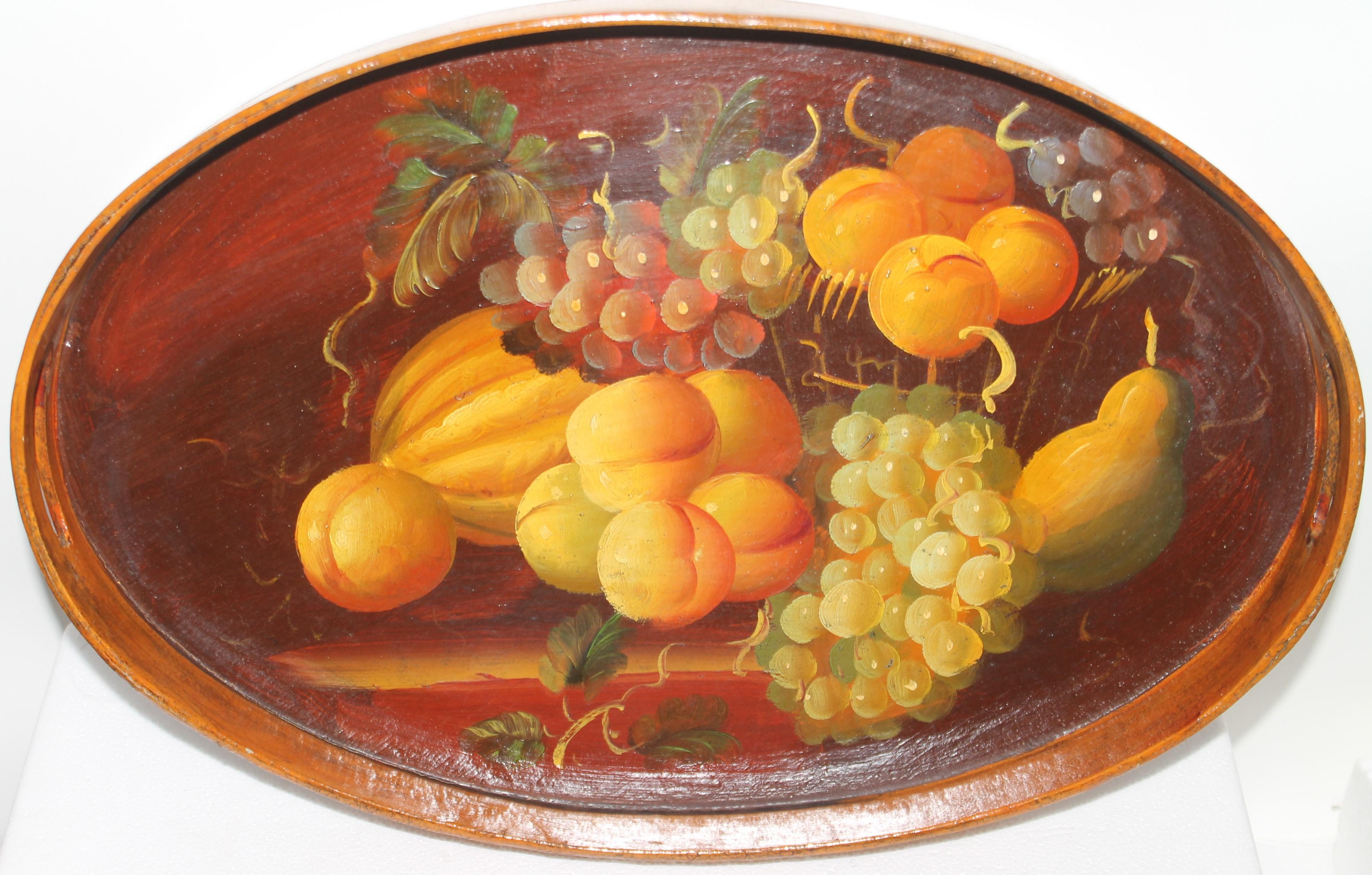 Hand painted wood fruit serving tray with double handles. The condition is very good. It looks like a very well done still life.