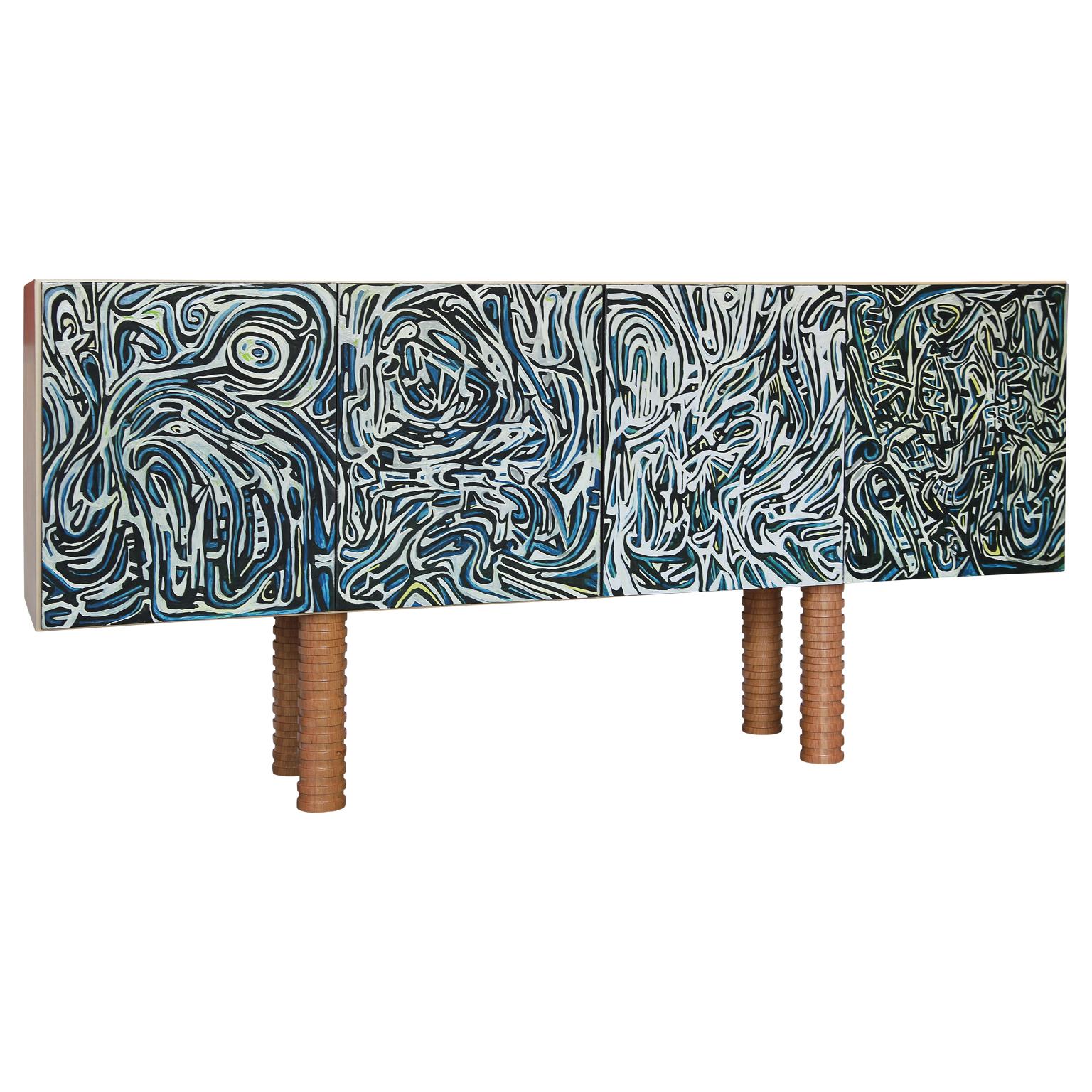 Fantastic custom painted abstract geometric sideboard by Michael Abramowitz X Reeves Art + Design.
Handmade in Houston Texas, this sideboard has four painted doors in blue, white, and black. Turned scalloped legs out of oak sit below. The interior