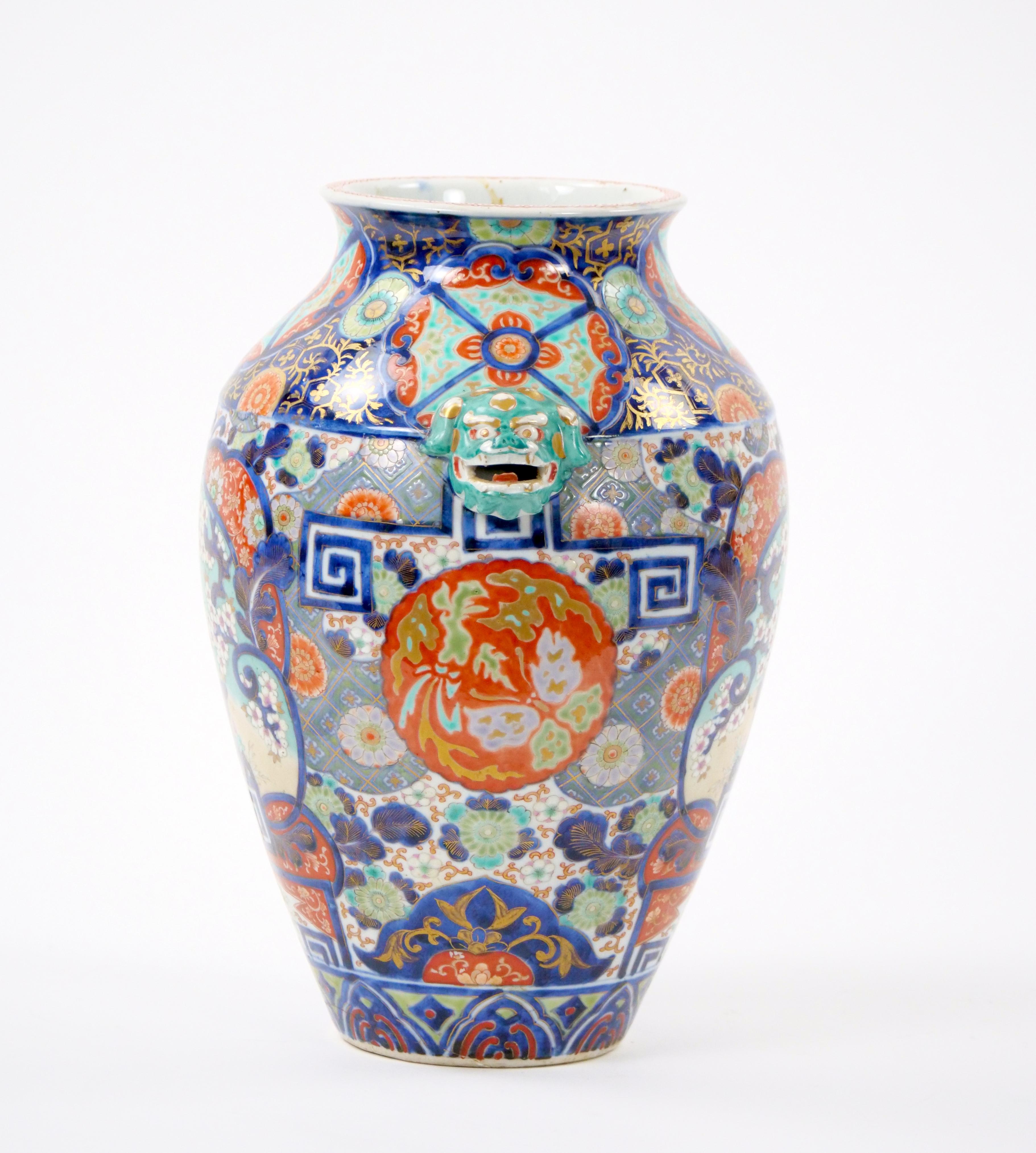 Transport yourself to the opulence of the 19th century with this exquisite Hand-Painted and Gilt Gold Decorated Imari Porcelain Vase, featuring a captivating foo dog side handle. Meticulously crafted, this vase is a testament to the artistry and