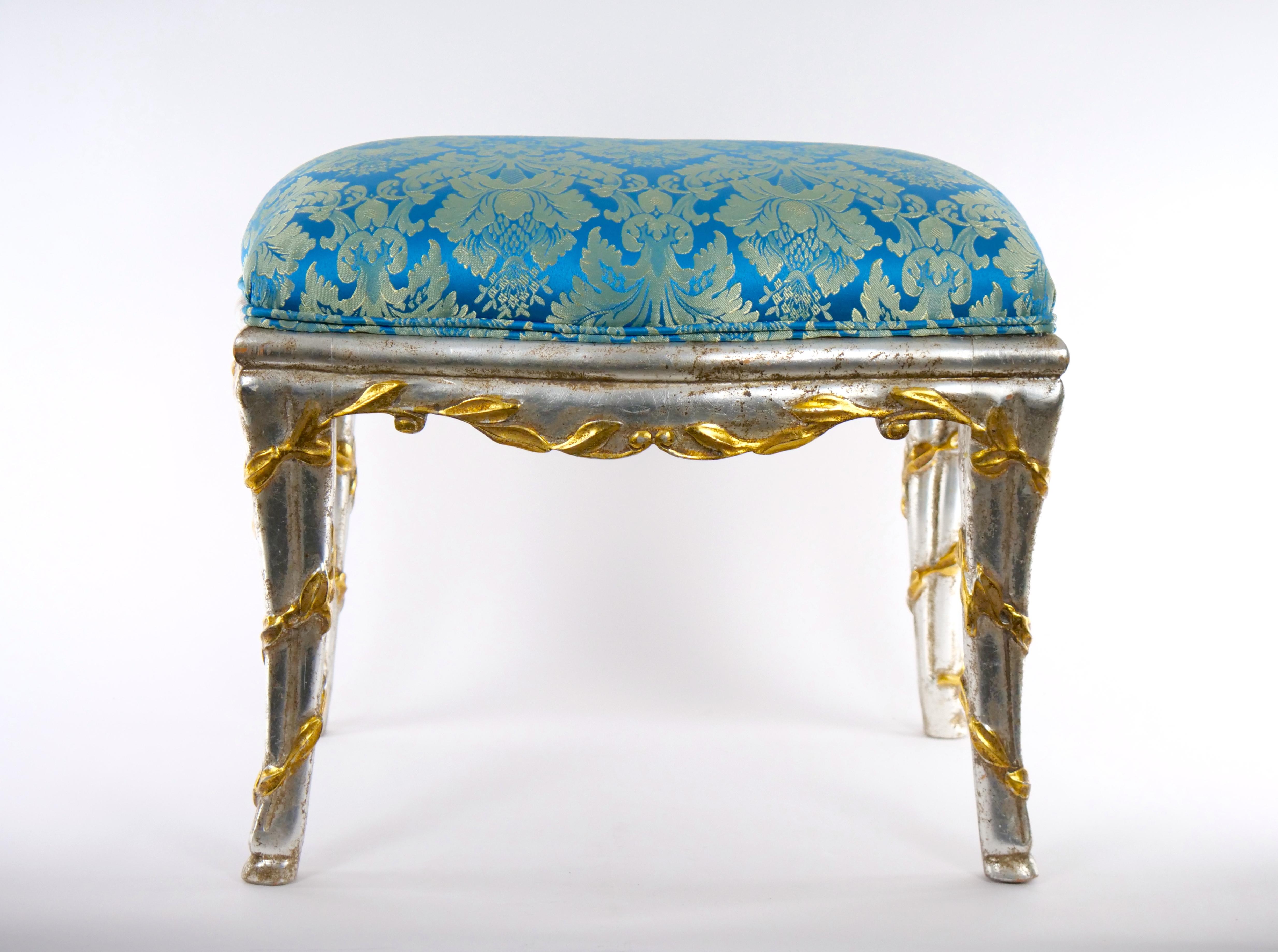 Mid-20th century Italian Louis XVI style hand painted wooden frame and hand decorated foliate design small bench with silk damask blend upholstered seat from the midcentury. This bench features hand carved fluted details legs decorated with hand