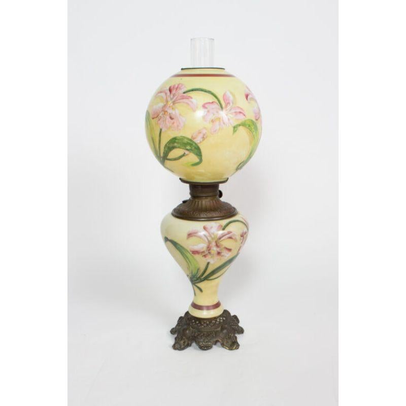 Hand painted base and shade. Cream glass painted with pink lilies.

Material: Glass,Brass
Style: Traditional, Victorian
Place of Origin: United States
Period made: Late 19th Century
Dimensions: 10 × 10 × 27 in
Condition Details: Excellent