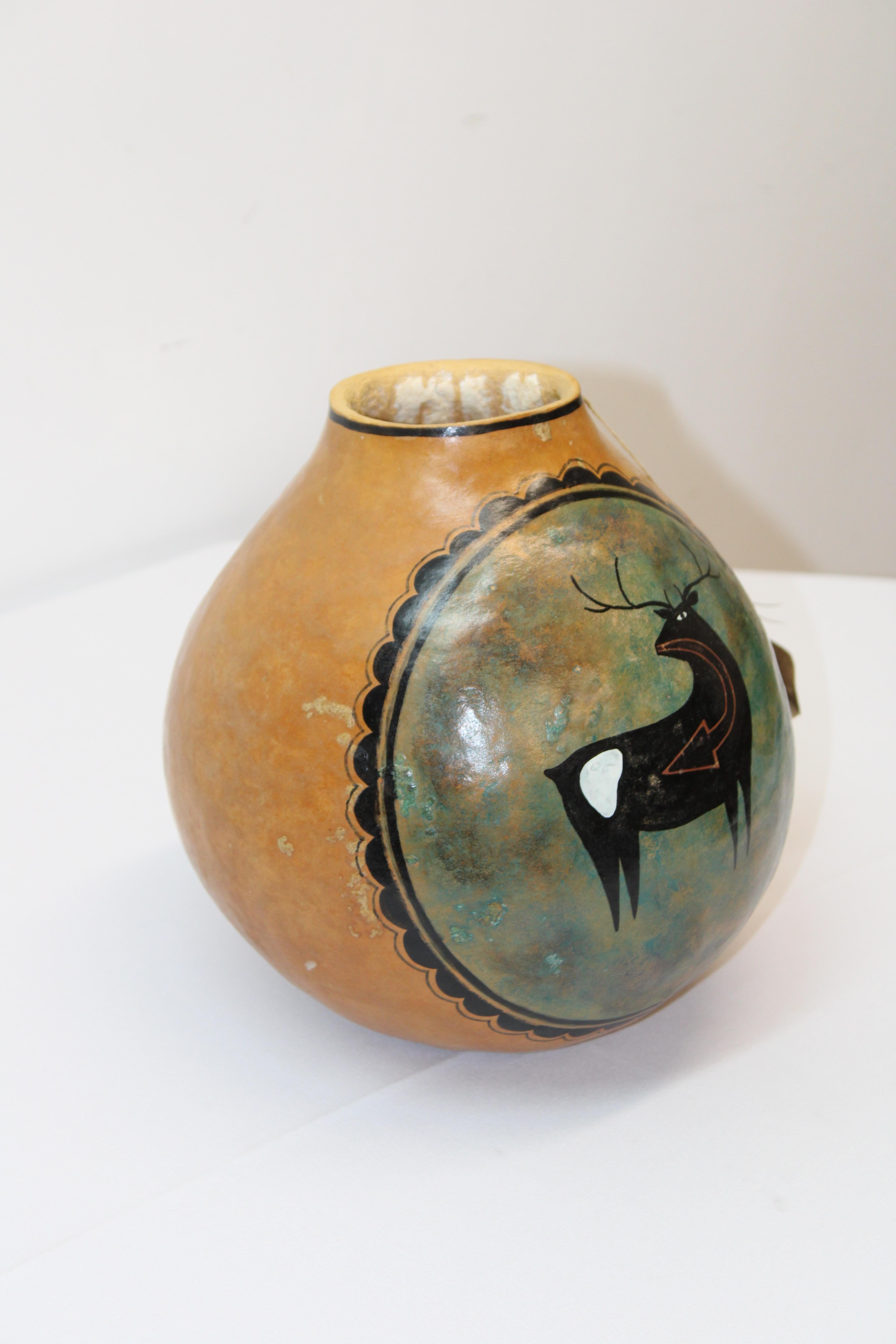 C. 20th century.

Adorable hand painted gourd by New Mexico Artist Robert Rivera.