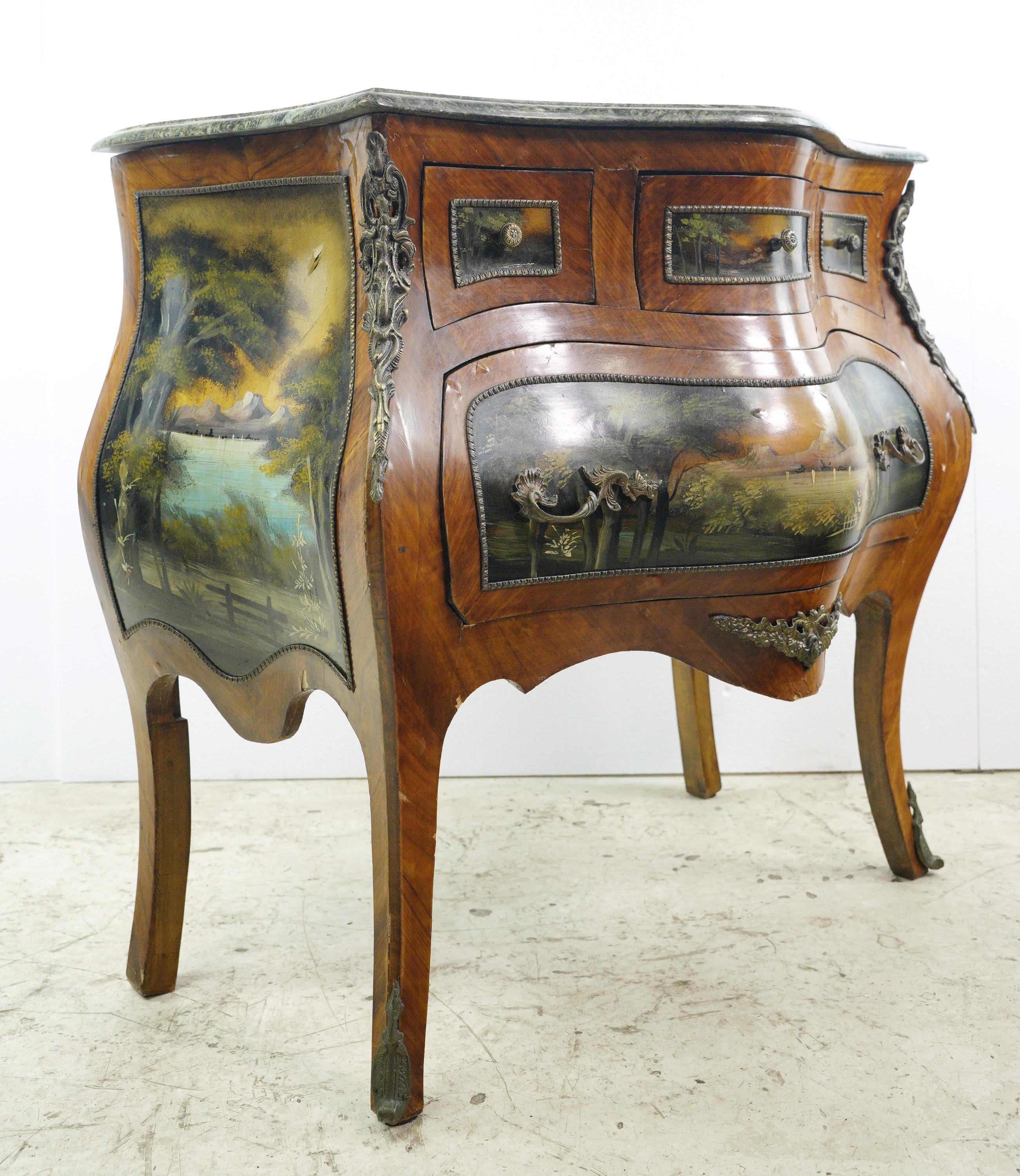 This hand painted green marble top Bombay console table boasts elegance and charm. Its exquisite design features four drawers featuring picturesque scenes, making it a stylish and practical addition to any living space. This is in fair condition,