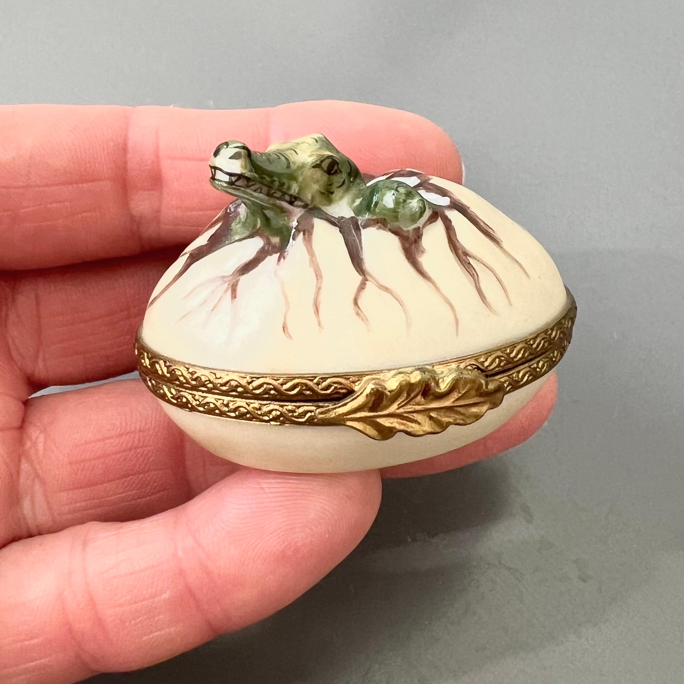 Add a touch of French charm and playful artistry to your collection with this delightful hand-painted Limoges porcelain box. Crafted in France and signed 