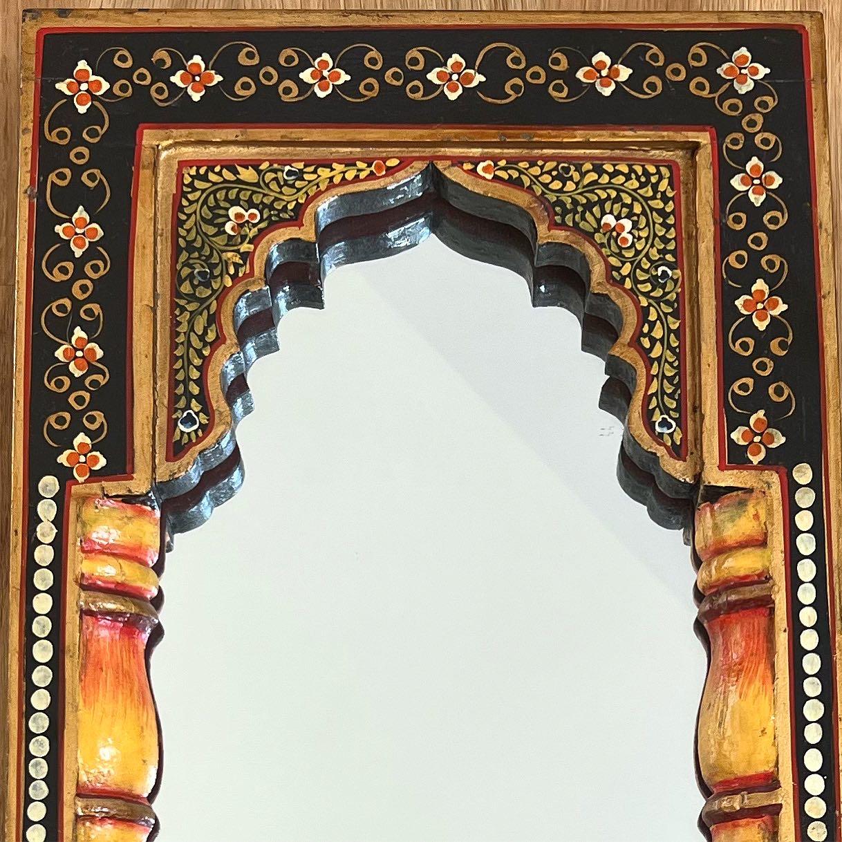 A vintage hand-painted Indian archway mirror, 1940s. Tones of tangerine, marigold, pomegranate, and ebony. Ready to hang. Faint signs of age but no outward flaws.
Dimensions:
10” x 13” x 1.25”.