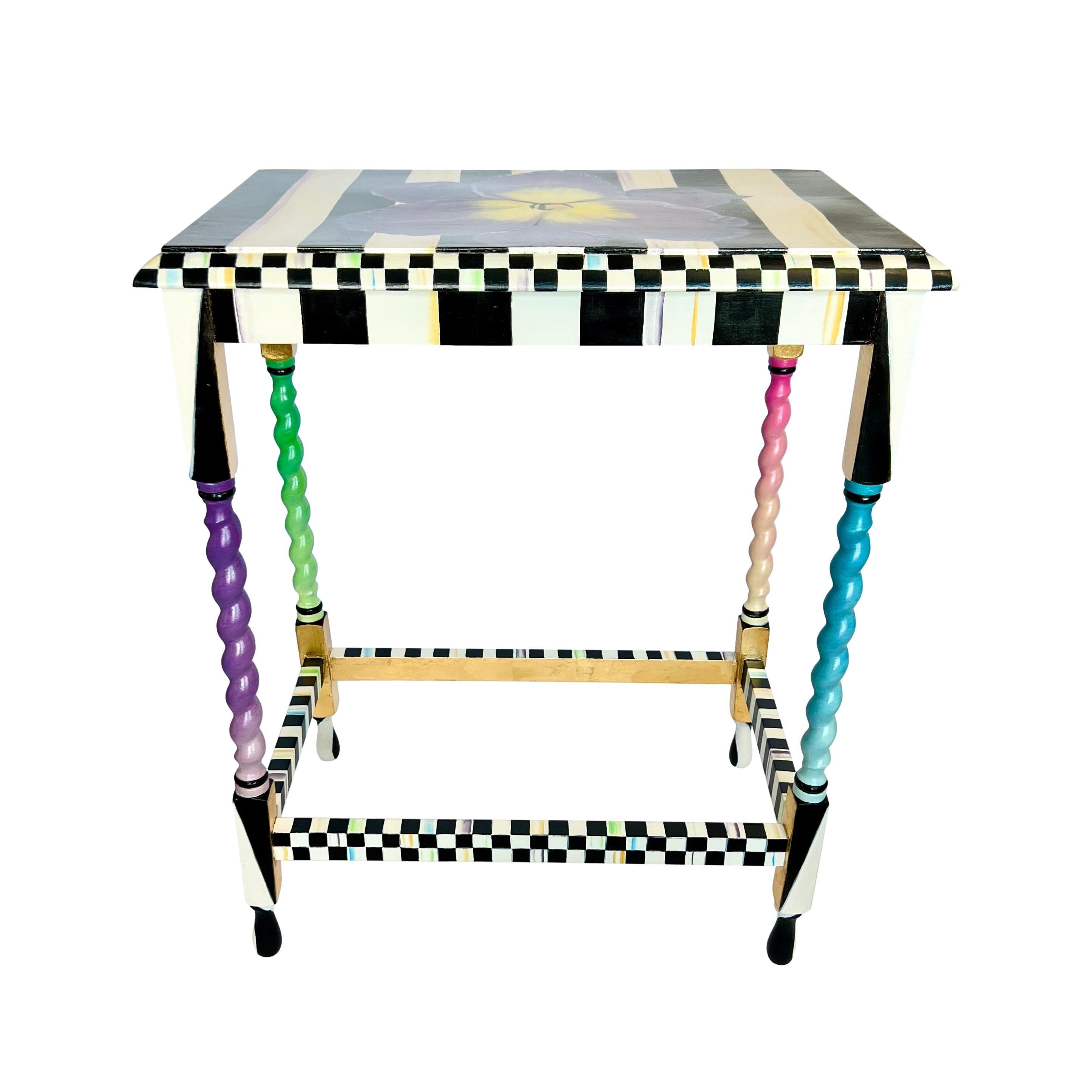 This antique English tall barley twist rectangular side table has been given a hand painted update in the manner of MacKenzie-Childs. The top of this one-of-a-kind piece features a centered purple iris flower over vertical cream and black stripes