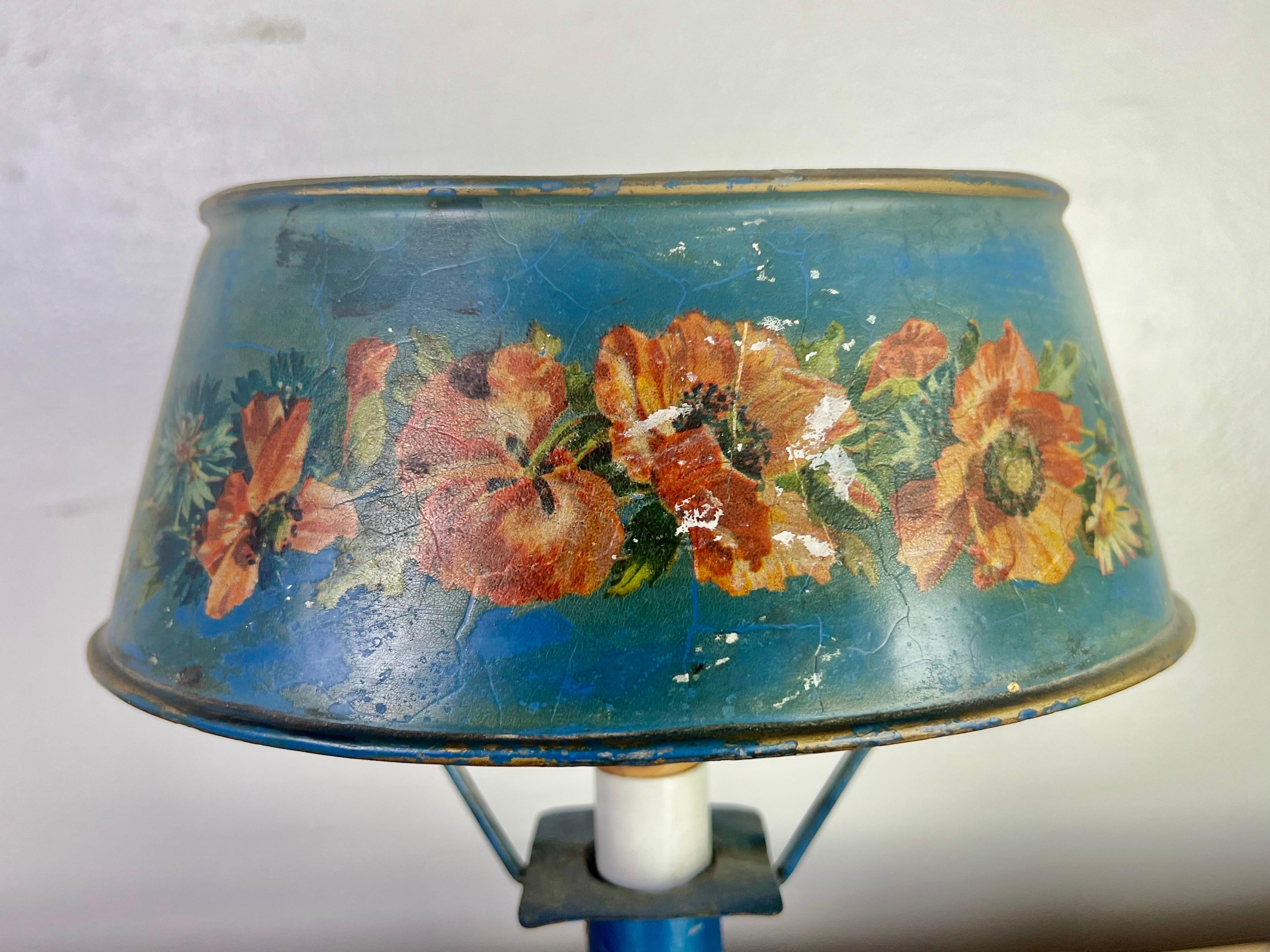 Charming hand painted Venetian tole lamp with coral & yellow colored flowers on a blue background. The lamp is in working condition.