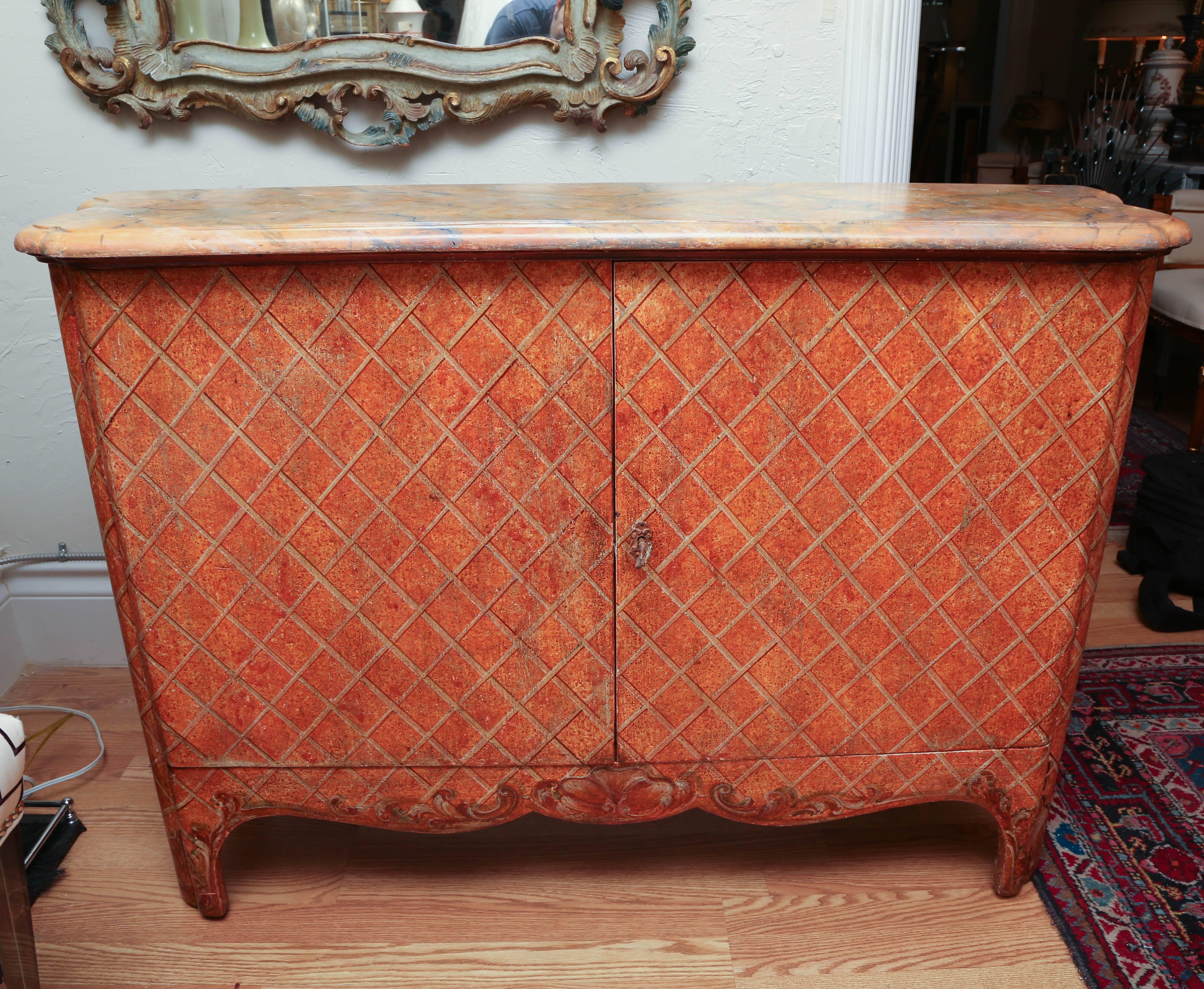 Two-door Italian hand-painted cabinet with an overall trellis design and faux marbleized top. Interior is paper with one shelf in center.