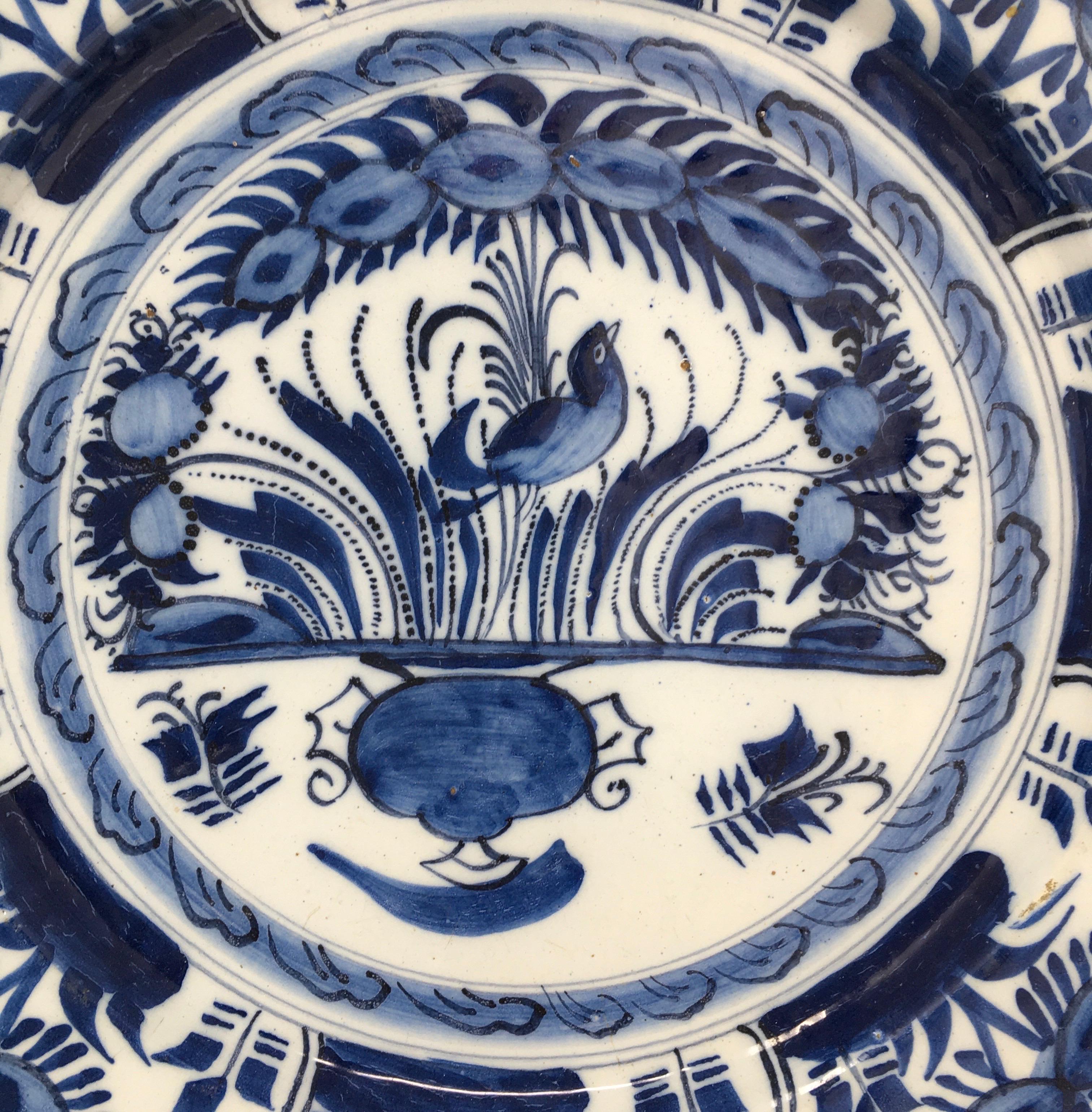 This hand painted Italian Deruta pottery bowl has a rich blue patina. The hand painted detail is lovely. It has some cracks and nicks that have been previously repaired. We do not believe that this scare detracts from the beauty of this shallow bowl.