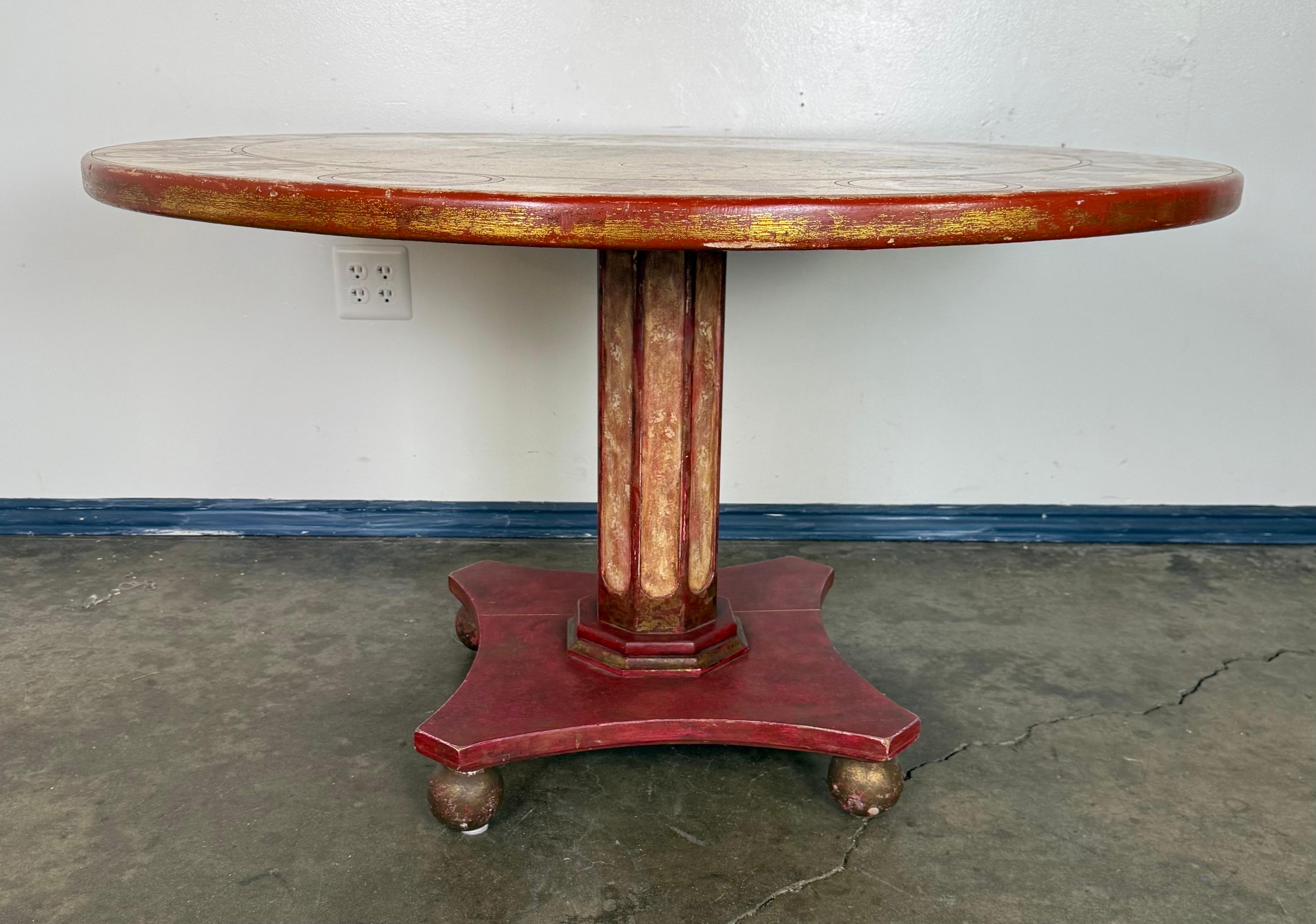 A striking round center table featuring a hand-painted top with a cartographic motif of the Eastern Hemisphere. The surface is decorated in the style of a Renaissance map, with detailed renderings of continents, seas, compass rose, sailing ships,