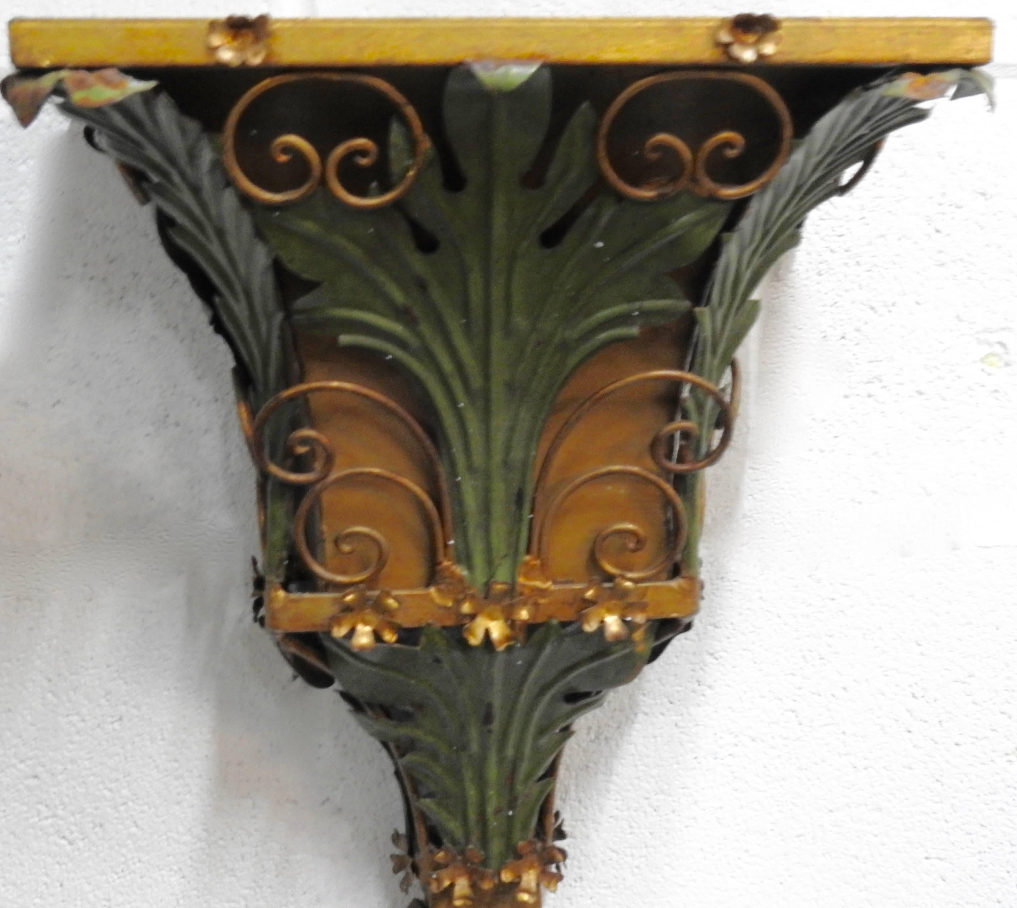 Leaves, scrolls, vines and flowers embellish this metal planter from Italy. Most of the surface is finished in a patinated gold and the leaves are in green. The top will hold your choice of greenery.