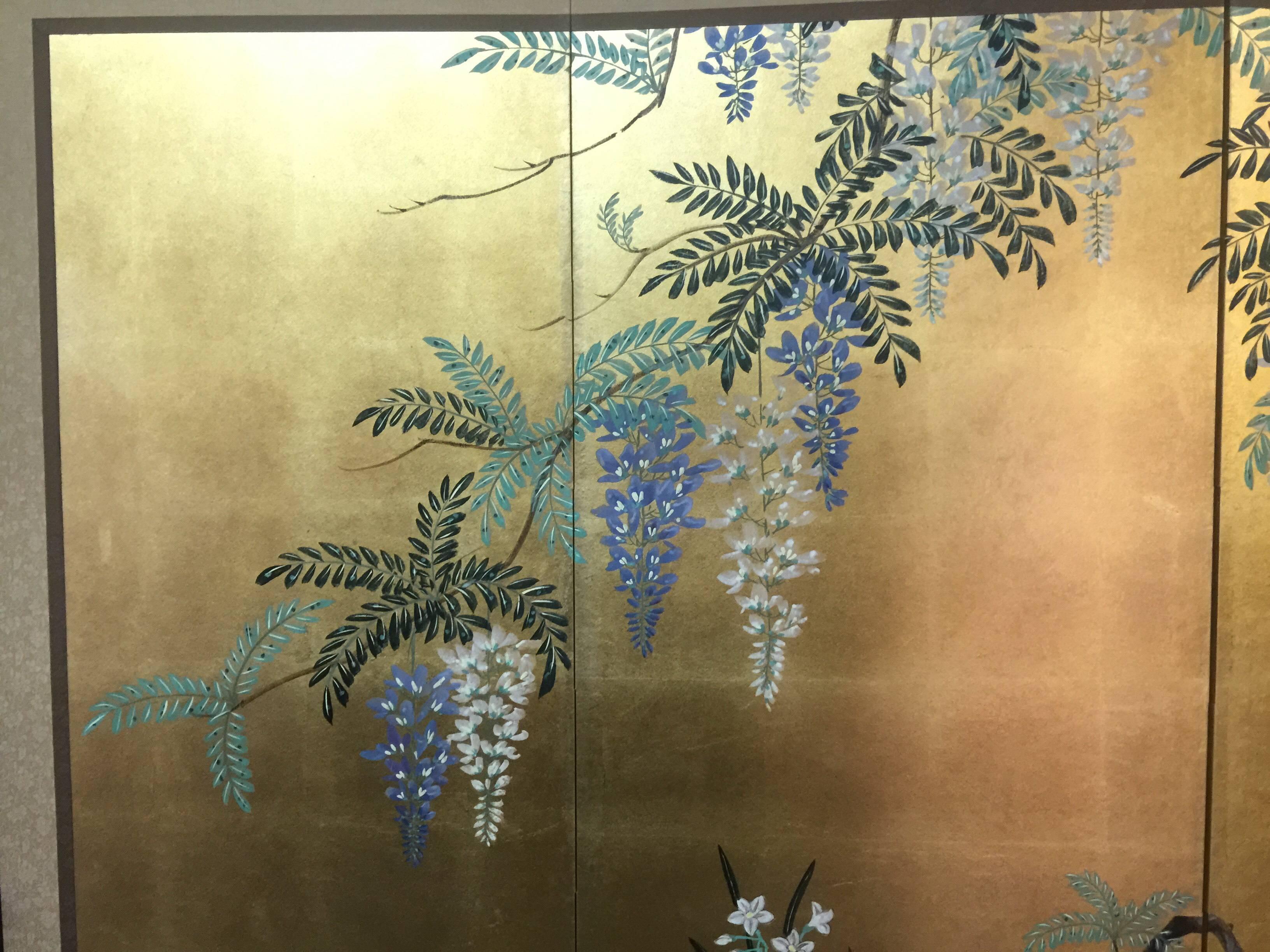 The wisterias and narcissus painting of this four-panel screen is hand-painted in watercolor, on squares of gold leaf which are applied by hand to the paper base over carefully jointed wooden lattice frames. Lacquer rails are then applied to the