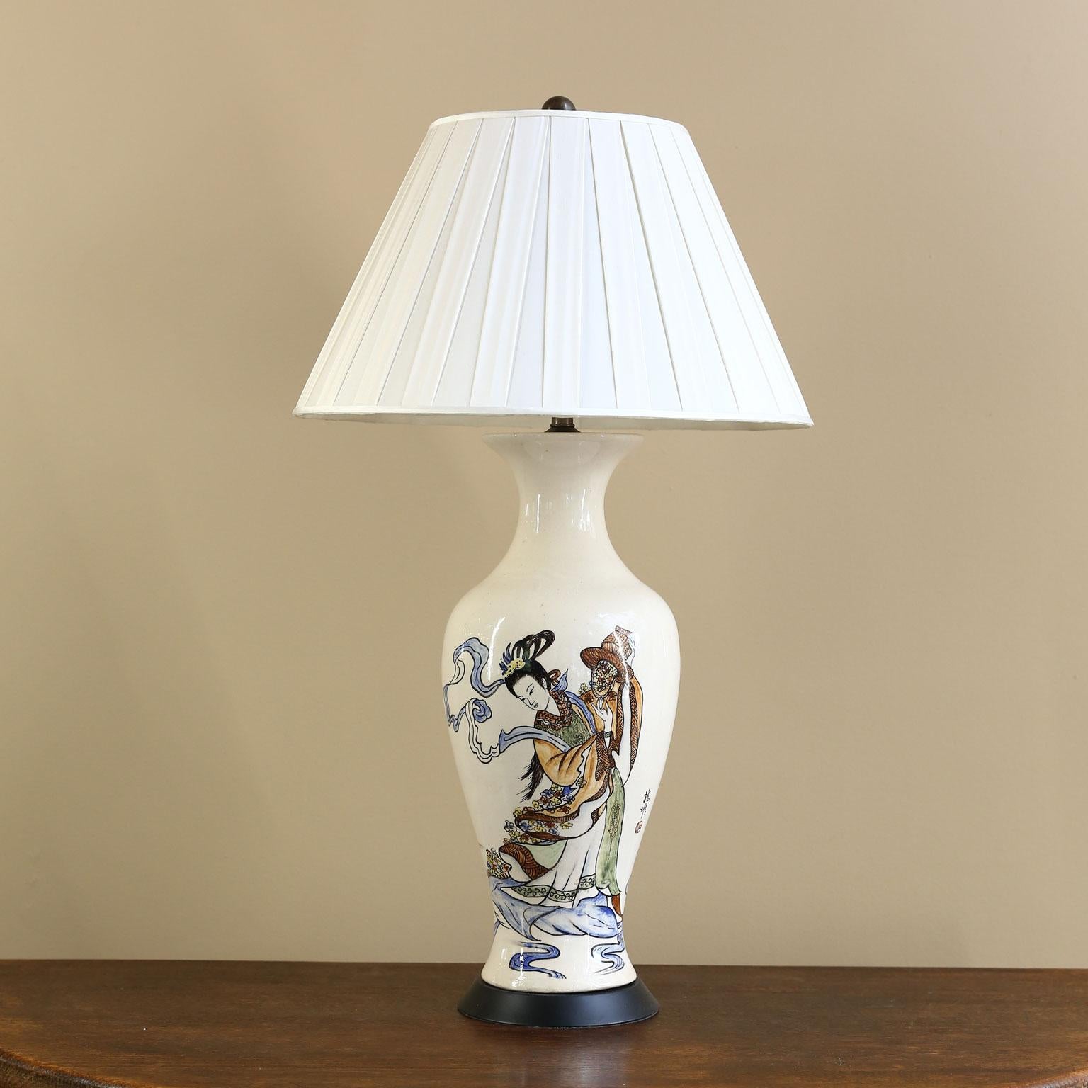 This charming lamp has art or the front of it and characters on the back of it. It has been newly wired for the US using all UL approved parts. We have photographed the lamp with a shade which is not included. (They are too difficult to ship.) The