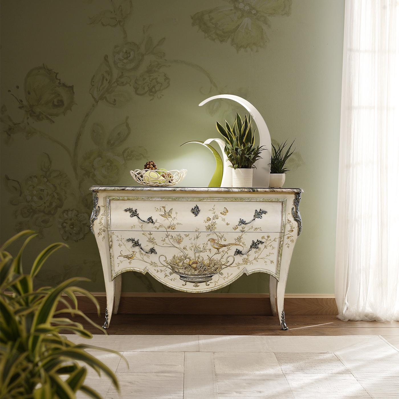 Distinguished by meticulous hand-painted designs on lacquered wood, this dresser exudes the serene beauty of nature's tranquility. Evoking a sense of timeless elegance, it features two drawers that enhance functionality without compromising style.