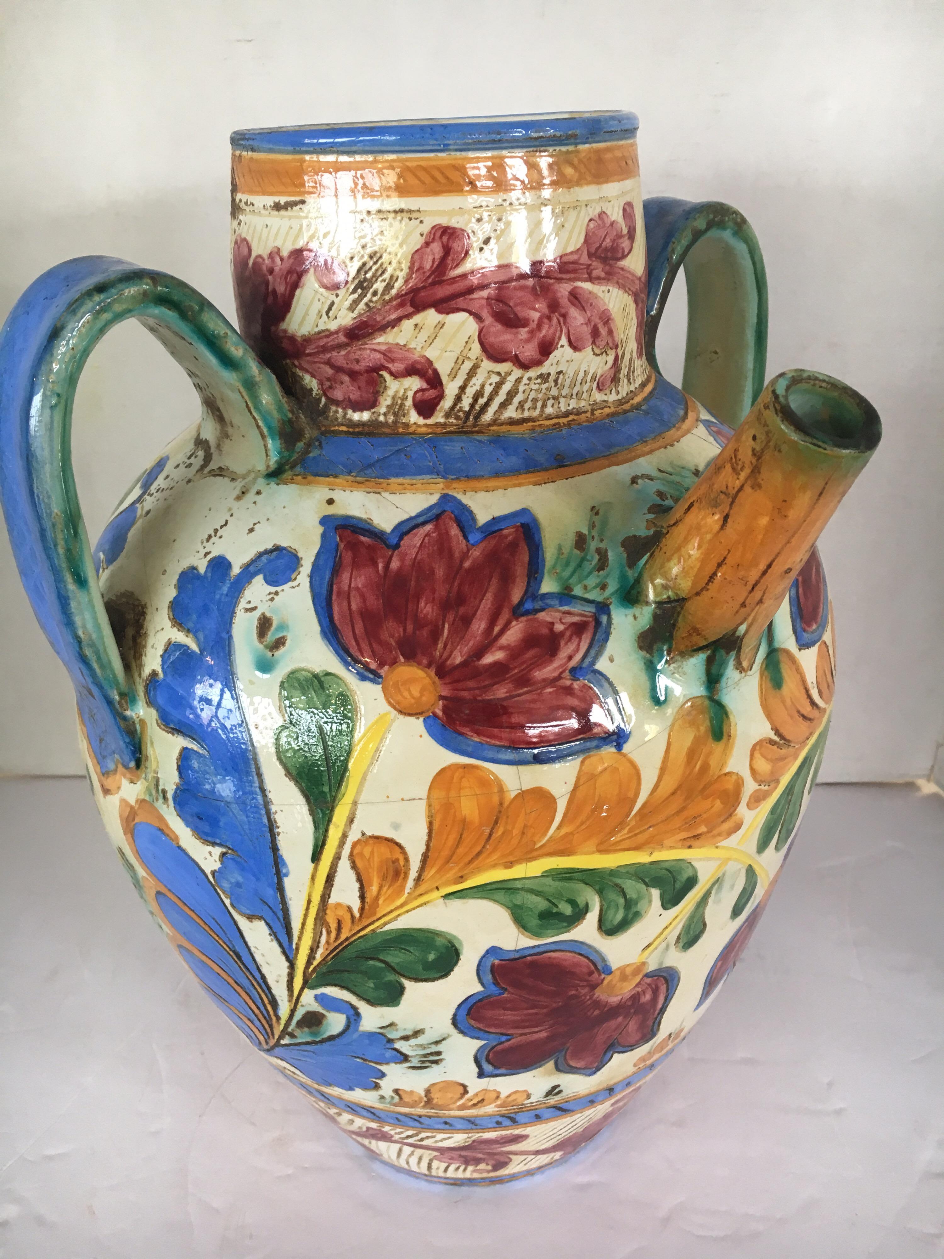 Hand painted large Italian garden water jug. Signed on bottom but illegible. There are some distress
crazing/cracks which add to the look of the piece. See pictures please.