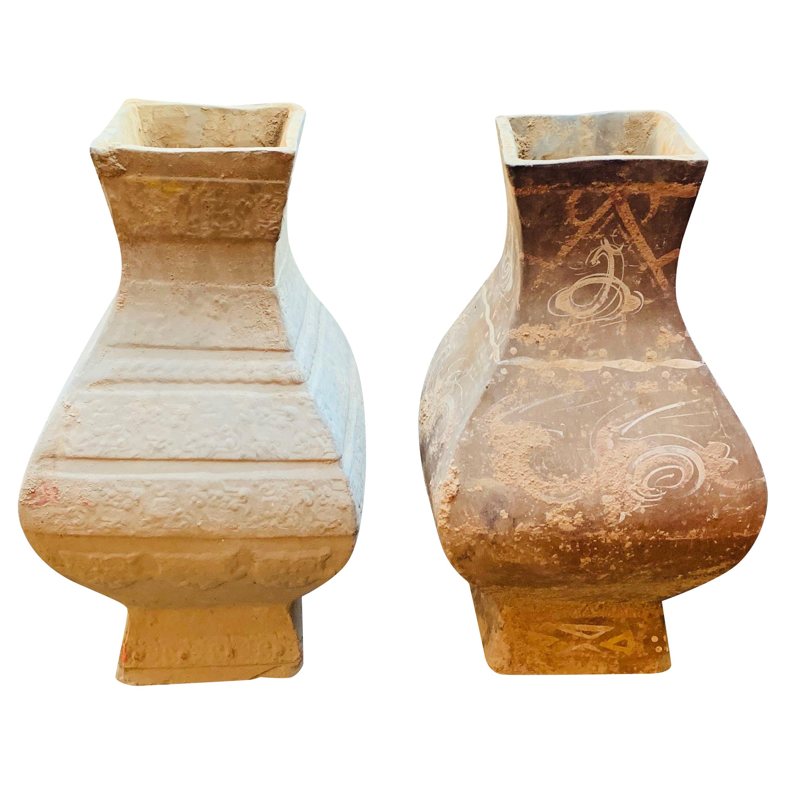 These two Chinese hand painted lidded vases are contemporary but the weathered patina is designed to look ancient.
Both have a finial shape with square top, each having a different hand painted design.
Two available and sold individually.
  