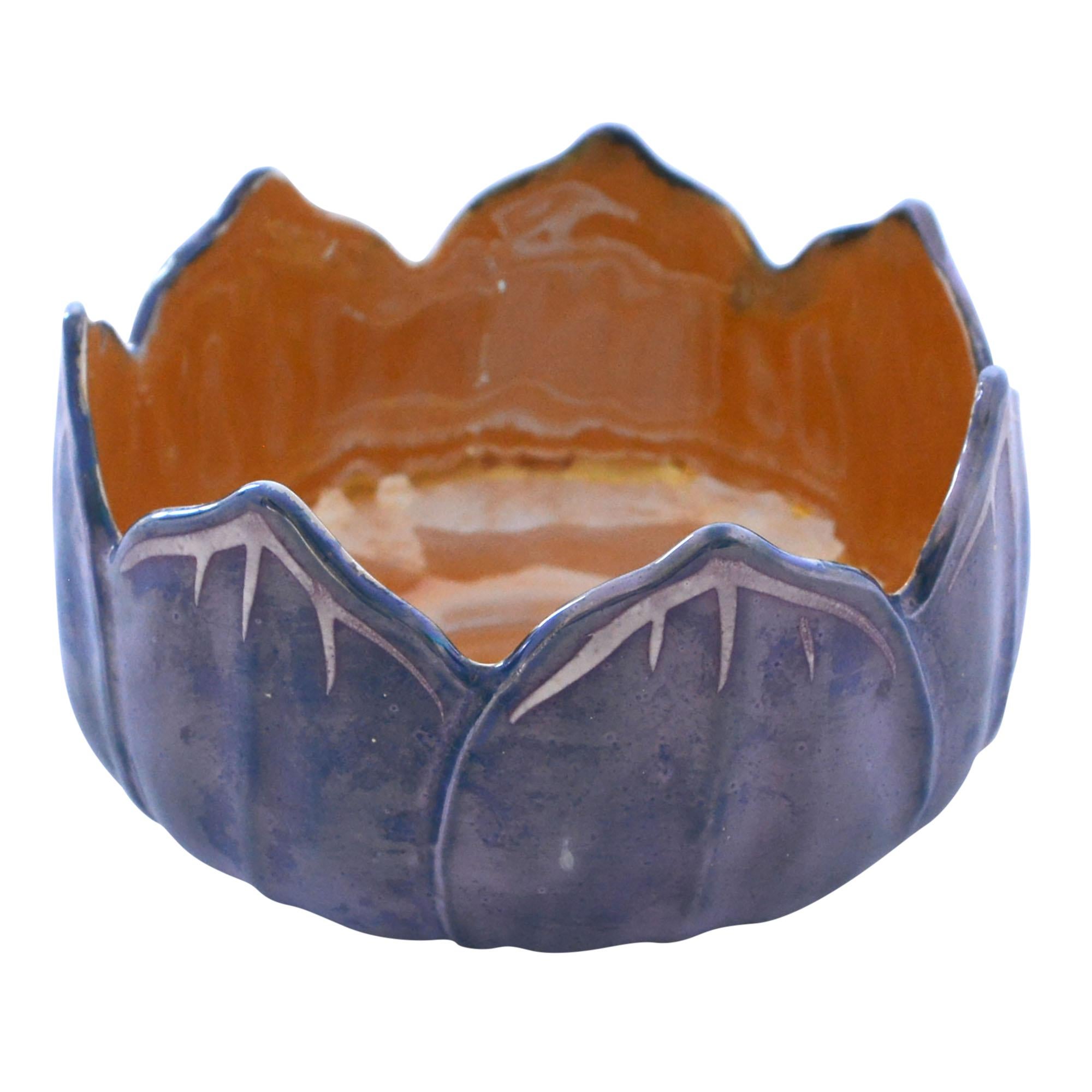 Lovely hand painted lusterware bowl is formed in the shape of lotus leaves. The inner bowl is finished in orange while the outer bowl is a beautiful lusterware blue with hand painted white details lining the leaves. Made in Japan.