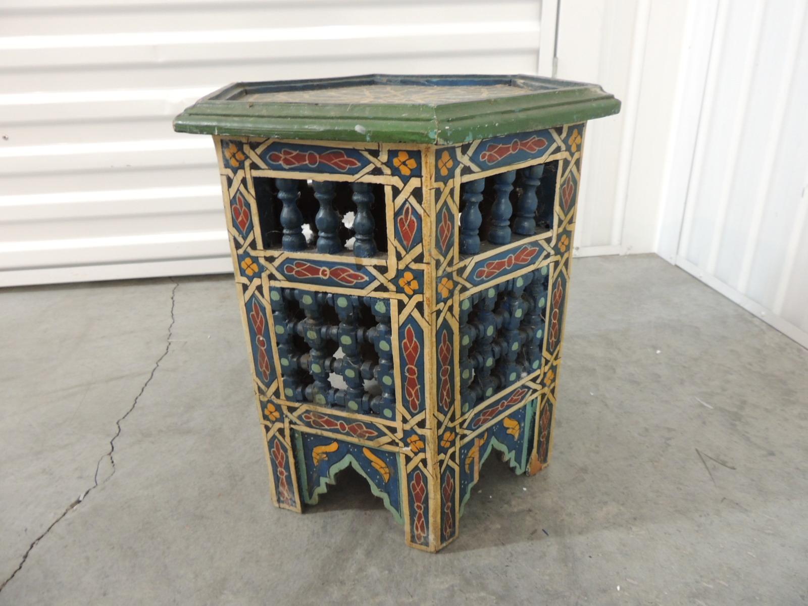 Hand painted Moroccan handcrafted side table or low drinks table.
Hexagonal shape with traditional Moroccan painted patterns with cutout trellis patterns and torn wood finials.
In shades of yellow, blue, red, green and aqua.
Ideal as a low table