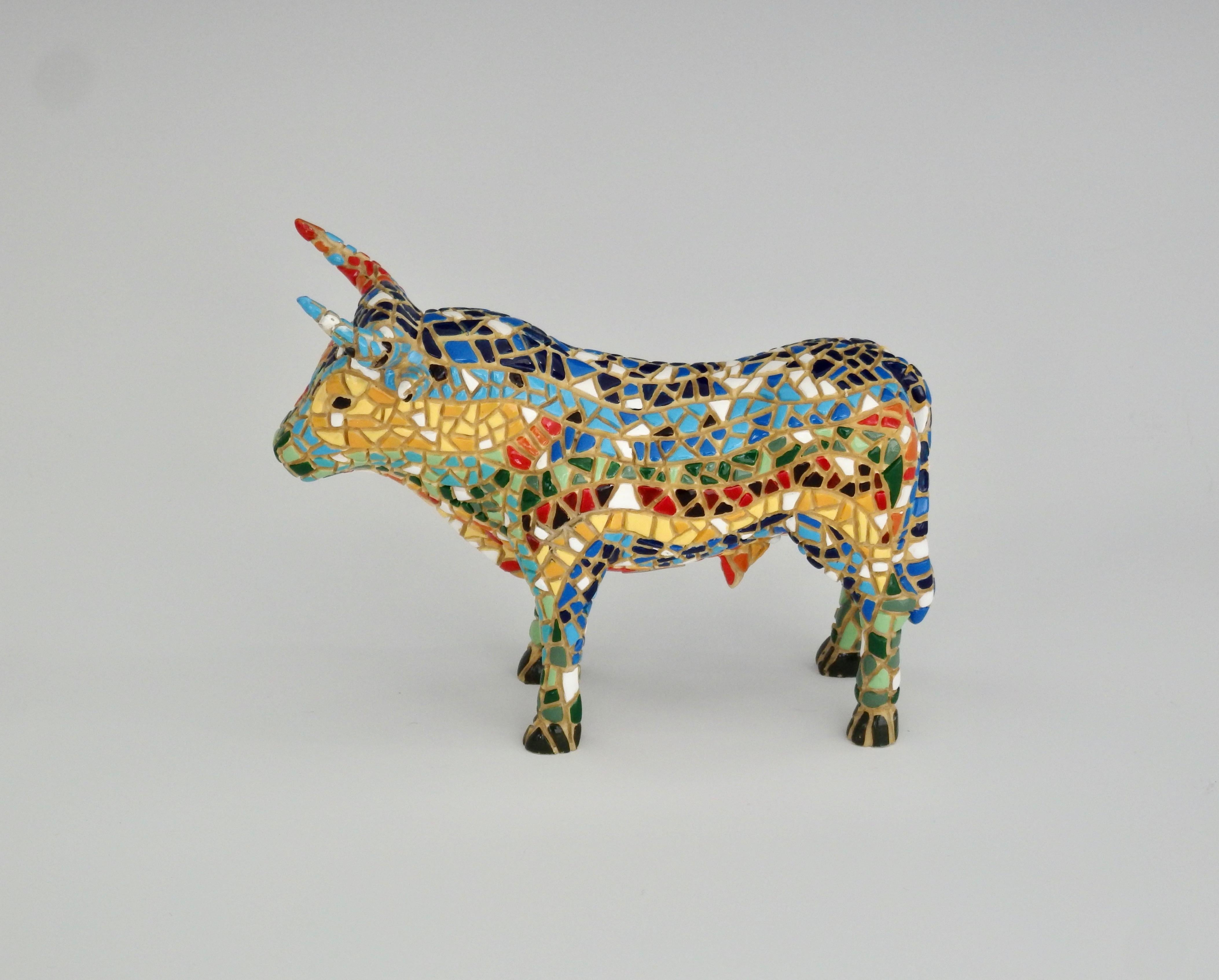 Intricately hand painted mosaic style with bright colors to give the bull form and definition.