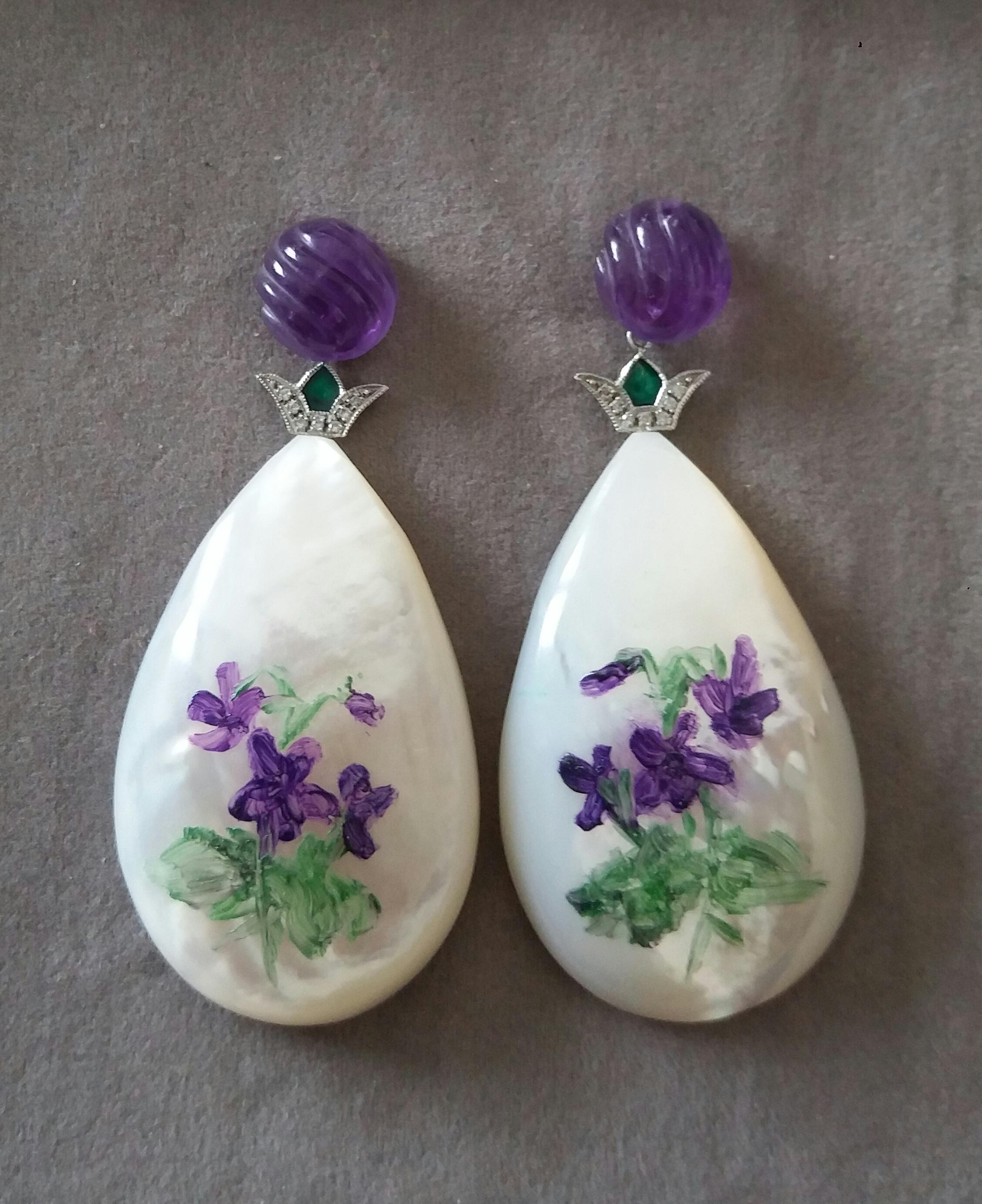 Hand painted pear shape Mother of Pearls  measuring 28x45 mm depicting a bunch of violets and its  foliage ,suspended from 2 Round Carved Amethyst measuring  10 mm  in diameter by 2 elements in 14 K white gold ,enamel and 14 small round brilliant