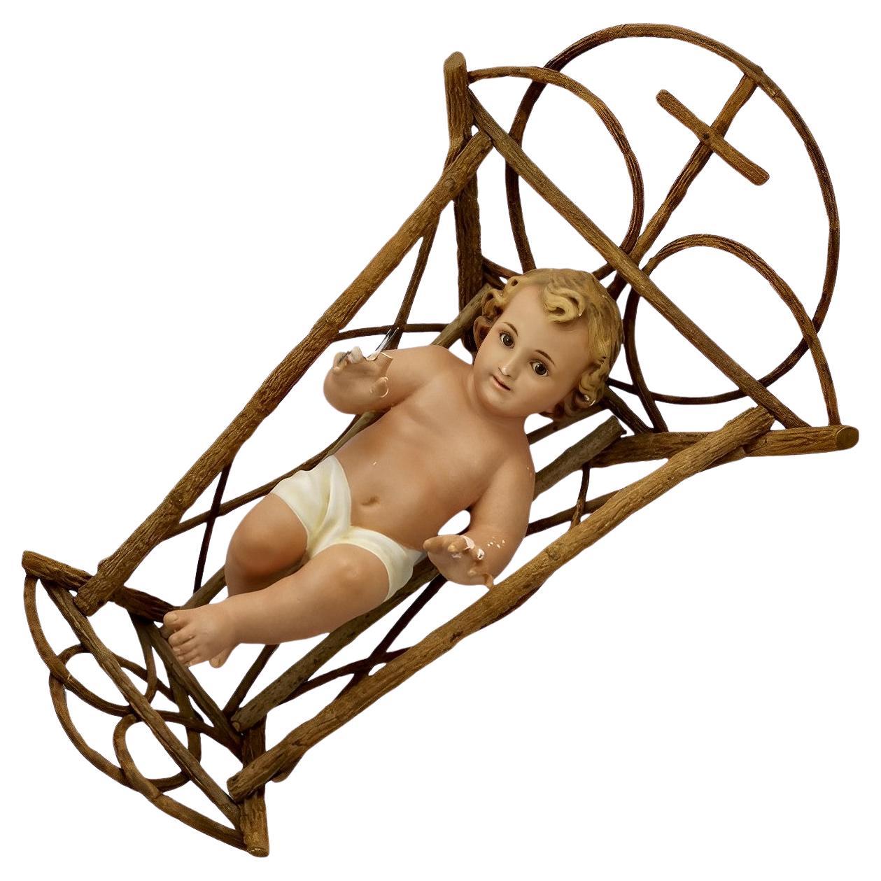 Hand Painted Plaster Baby Jesus in a Wooden Cradle  For Sale