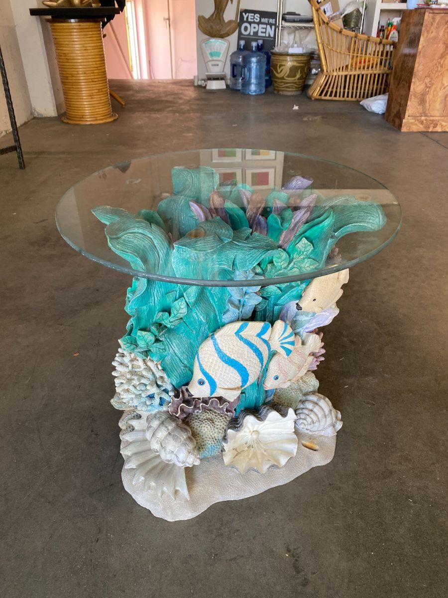 Hand painted plaster aquatic side table by Domestications featuring a beautiful reef with seaweed, fish and seashells.

Circa 1998.