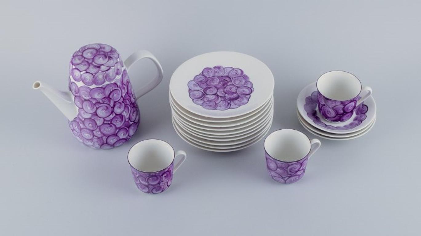 Hand-painted porcelain coffee set in a retro style with violet colors. 
Comprising of three pairs of coffee cups with saucers, coffee pot, and ten plates.
From the 1970s.
In perfect condition.
Signed with the artist signature CBL.
Coffee pot: H 16.3
