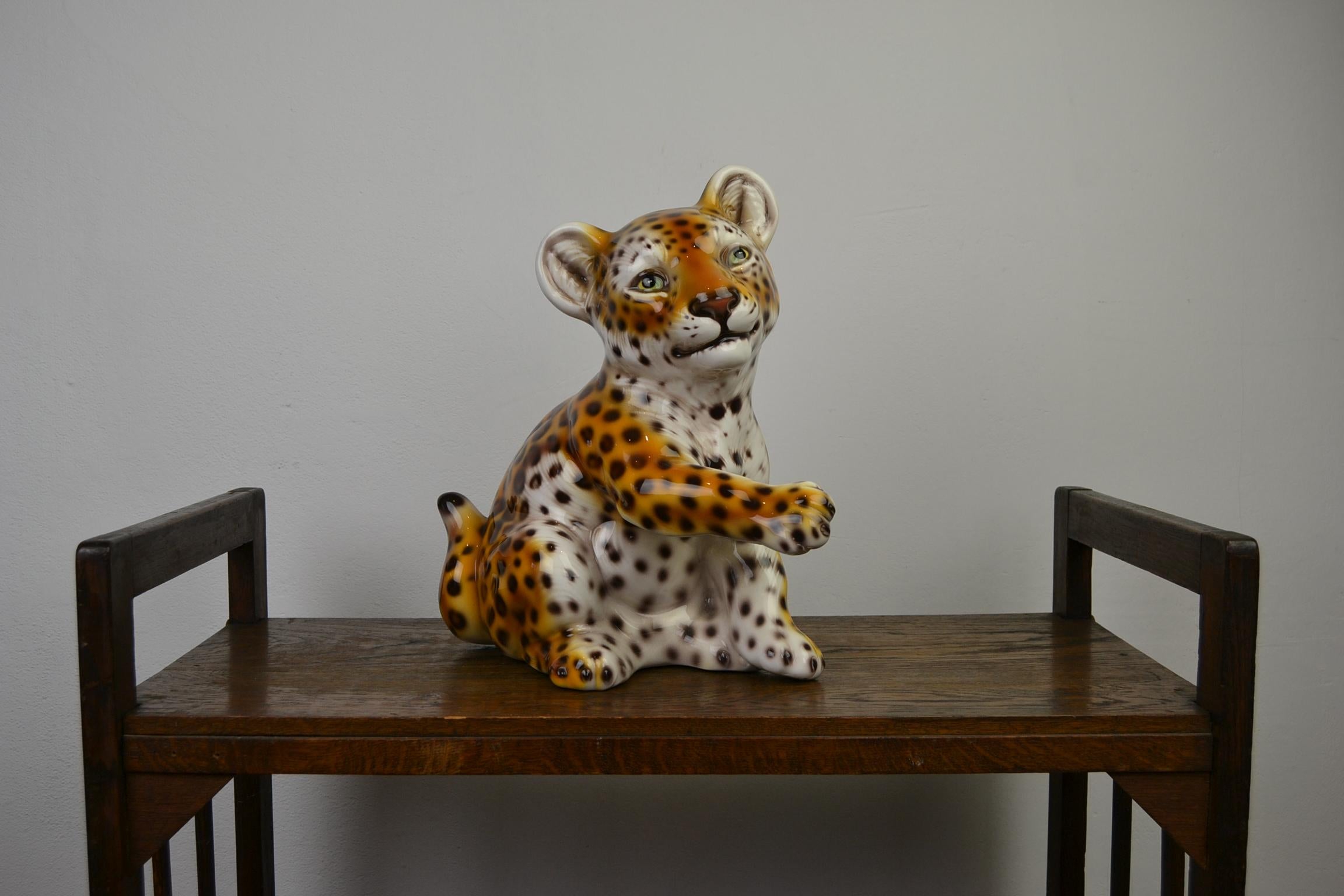 Cute looking Leopard Sculpture - made in Italy.
This Porcelain Animal Sculpture - Wild Animal is Hand-Painted - circa 1970s. 
Still in very good vintage Condition, no cracks.
Sitting in a lovely Position so you almost want to cuddle him the whole