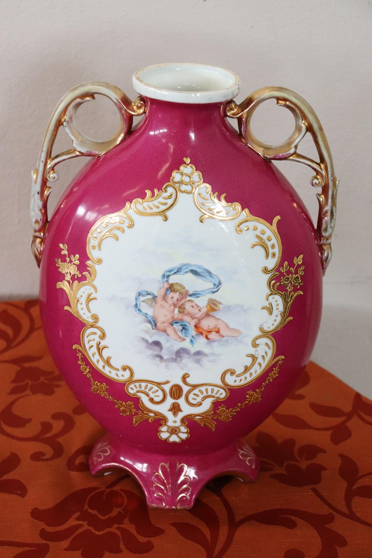 Beautiful fine porcelain pair of vase signed Victoria Carlsbad Austria, 1895. On the front scene with angels in the clouds. Precious golden handles. Present signs of wear and the passage of time please look at all the pictures.