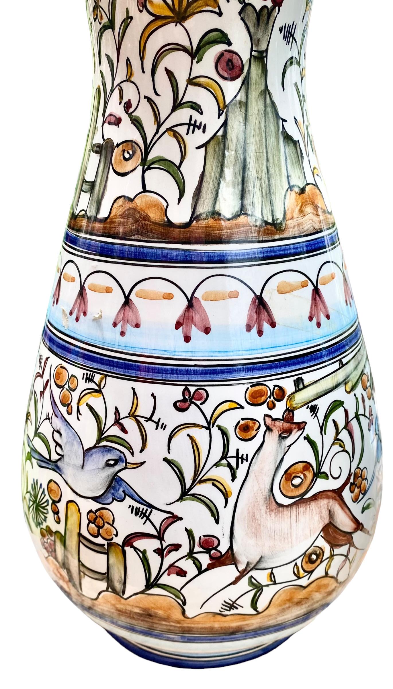 A large, vintage and colorful, Portuguese faience, water pitcher, with playful scenes of everyday farm life filled with flora and fauna. Lovely to display in your country kitchen or dining room.