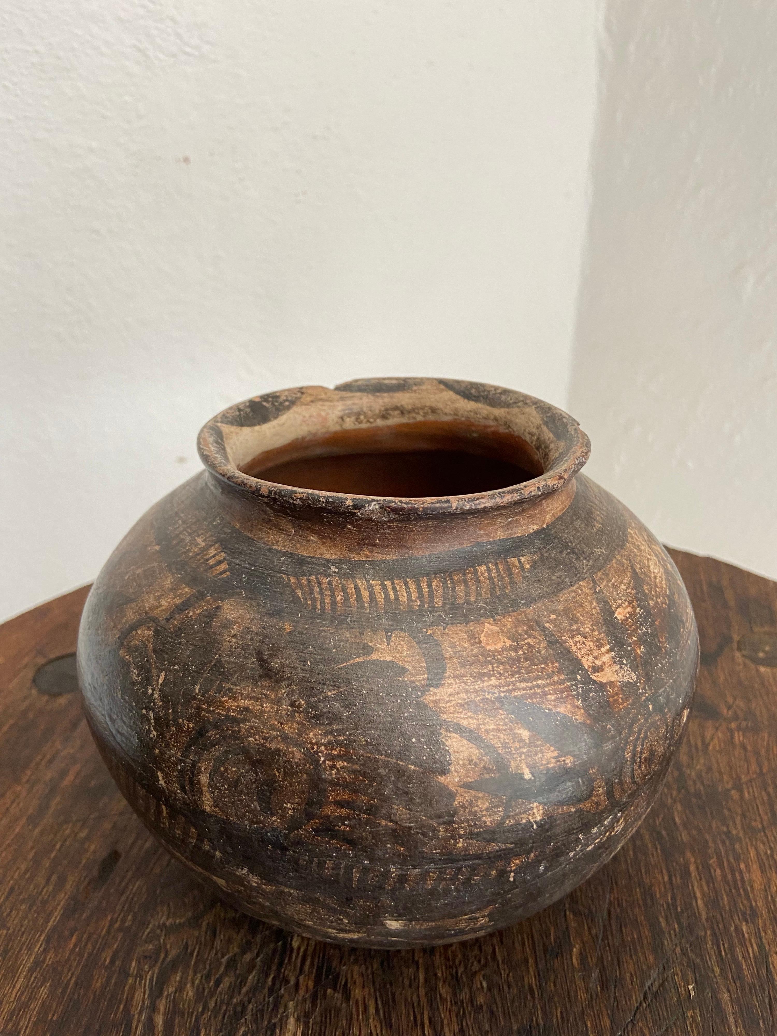 Hand painted pot from Mexico's Huasteca region, circa 1970's. Nahuatl is the indigenous language predominantly spoken in the area. The pot is most likely from the community of Chililico, Hidalgo. These pots are painted using a feather which gives