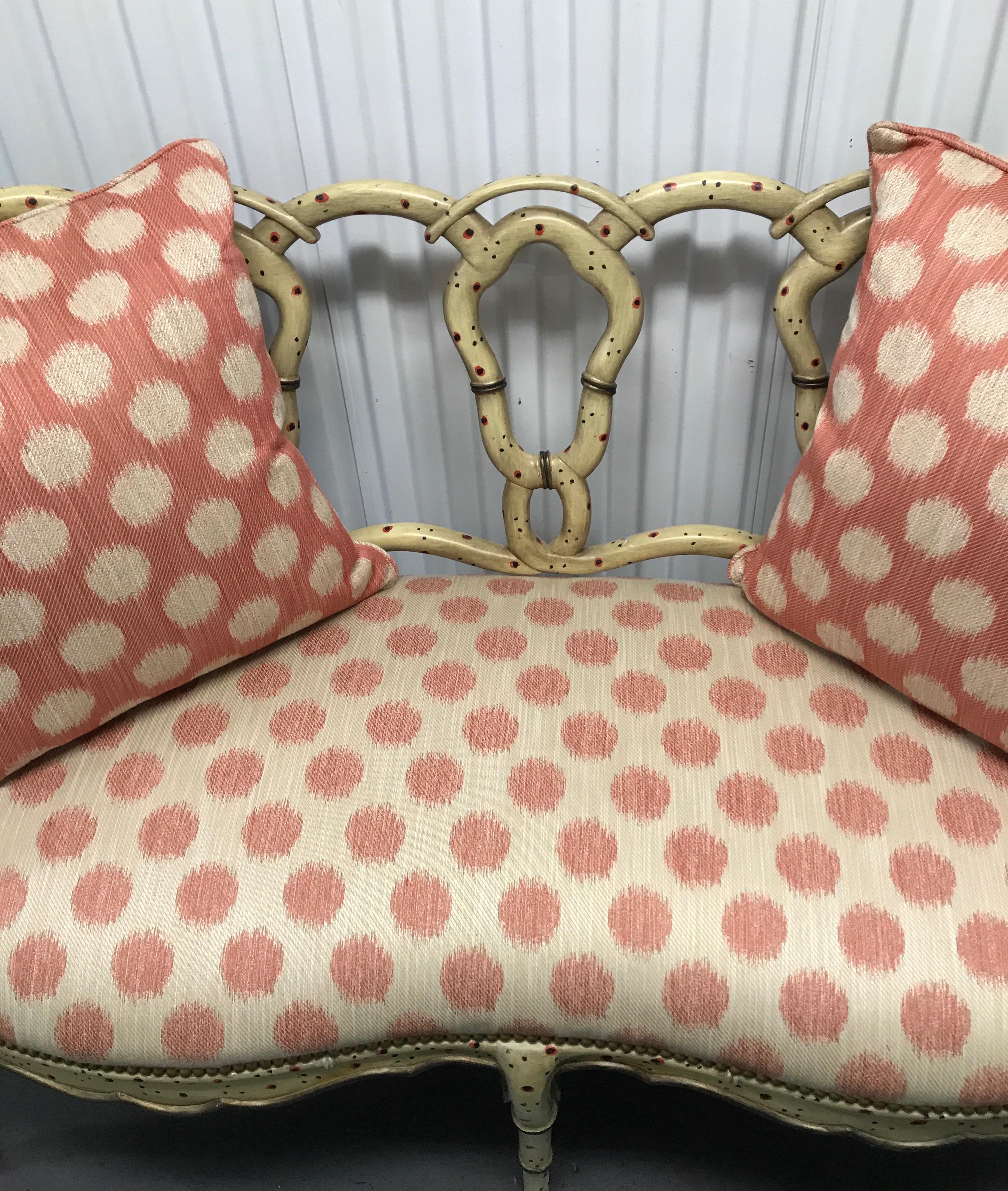 Whimsical hand painted wood loveseat with twisted pretzel back and upholstered seat.