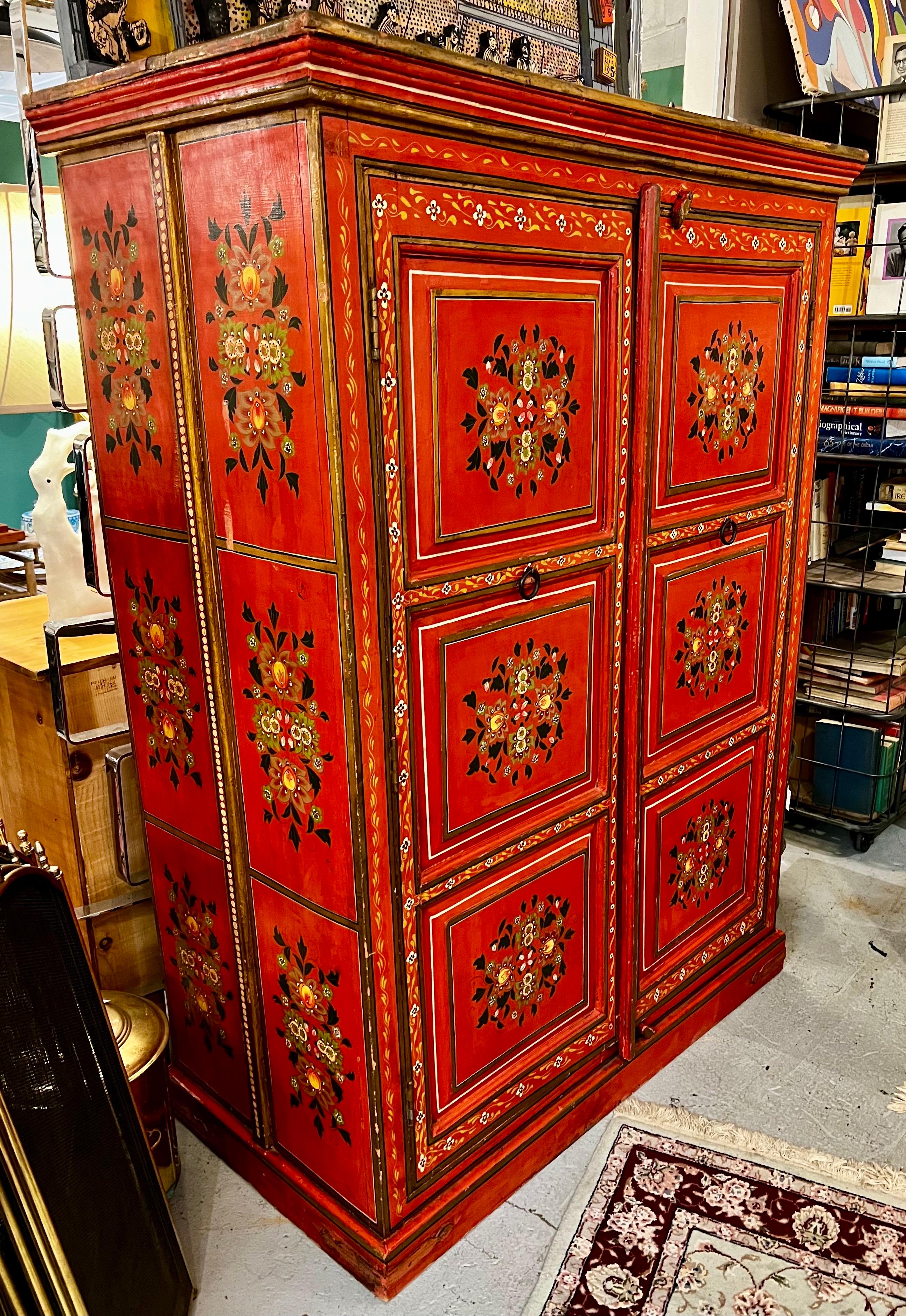 This exquisite red hand-painted Moroccan linen press showcases intricate geometric designs, making it a stunning focal point for any room.  Inside, it features spacious shelves, perfect for organizing your belongings or displaying cherished family