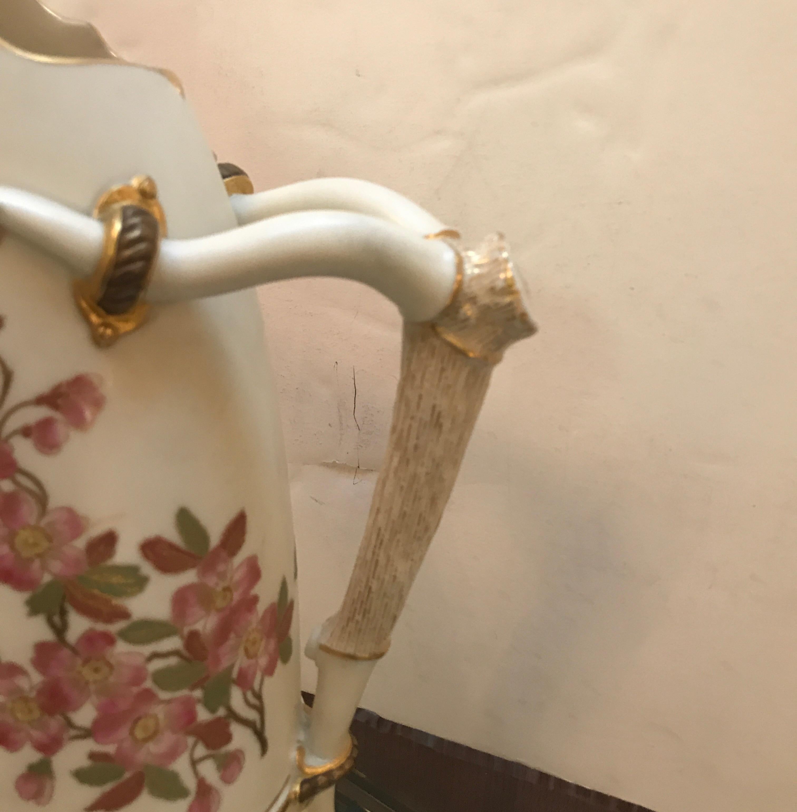 19th century hand painted Royal Worcester stag Horn handled pitcher. The tusk shape with floral decoration all around with a porcelain stag Horn style handle. The edges with original gilt decoration. Marked on the bottom with the Royal Worcester