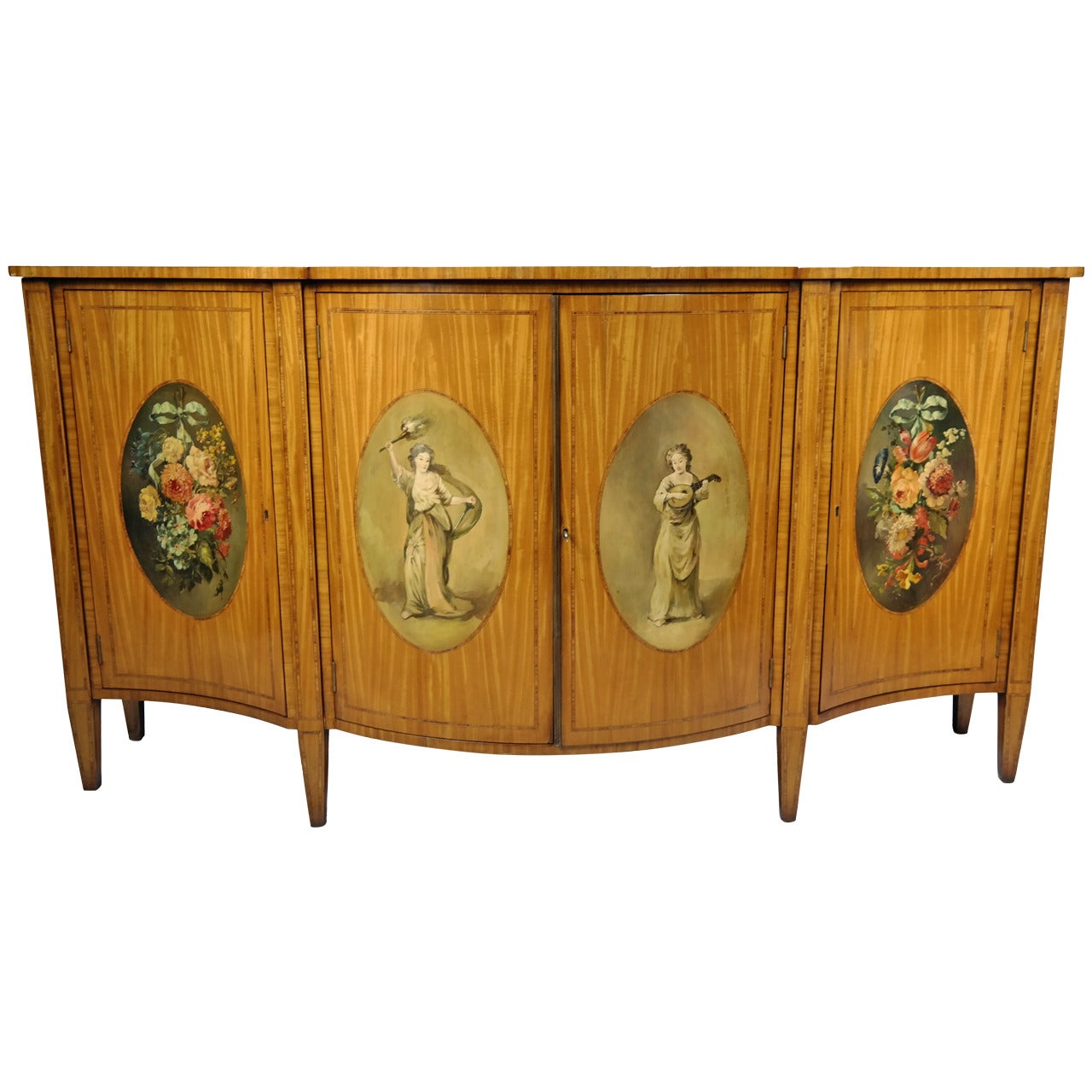 Satinwood and polychrome-painted serpentine front credenza, the central left cabinet door impressed, 'Harrods,' with the illustrious firm's metal label, 'Harrods, Ltd., London, S.W.1' on back, English, mid-20th century.
   