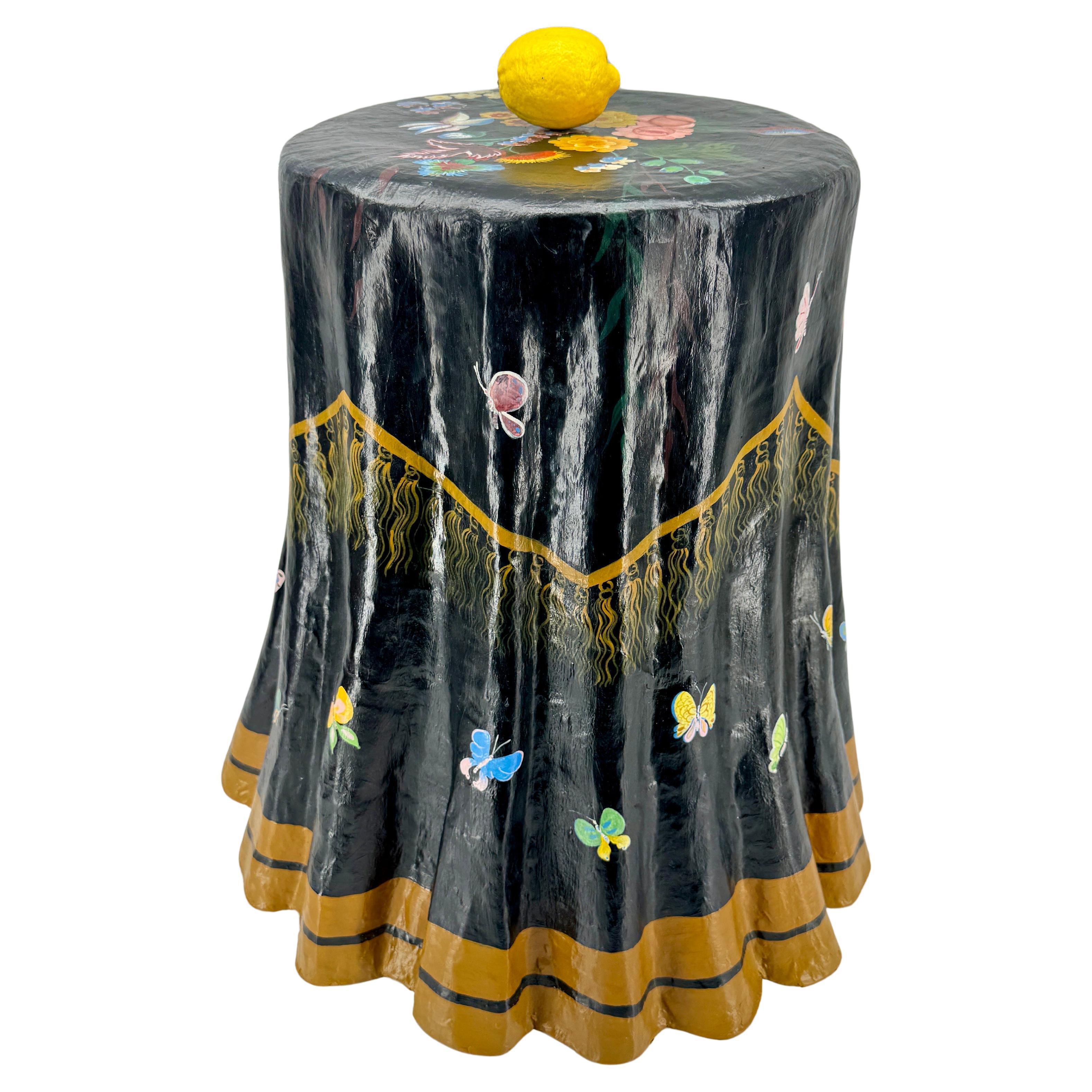 Papier Mache Black Multi-Colored Side Table
A beautiful example of elegance, a hand painted paper mache table. This side table is made to look like a tablecloth with a graceful draped effect. Decorated with hand painted flowers, butterflies and