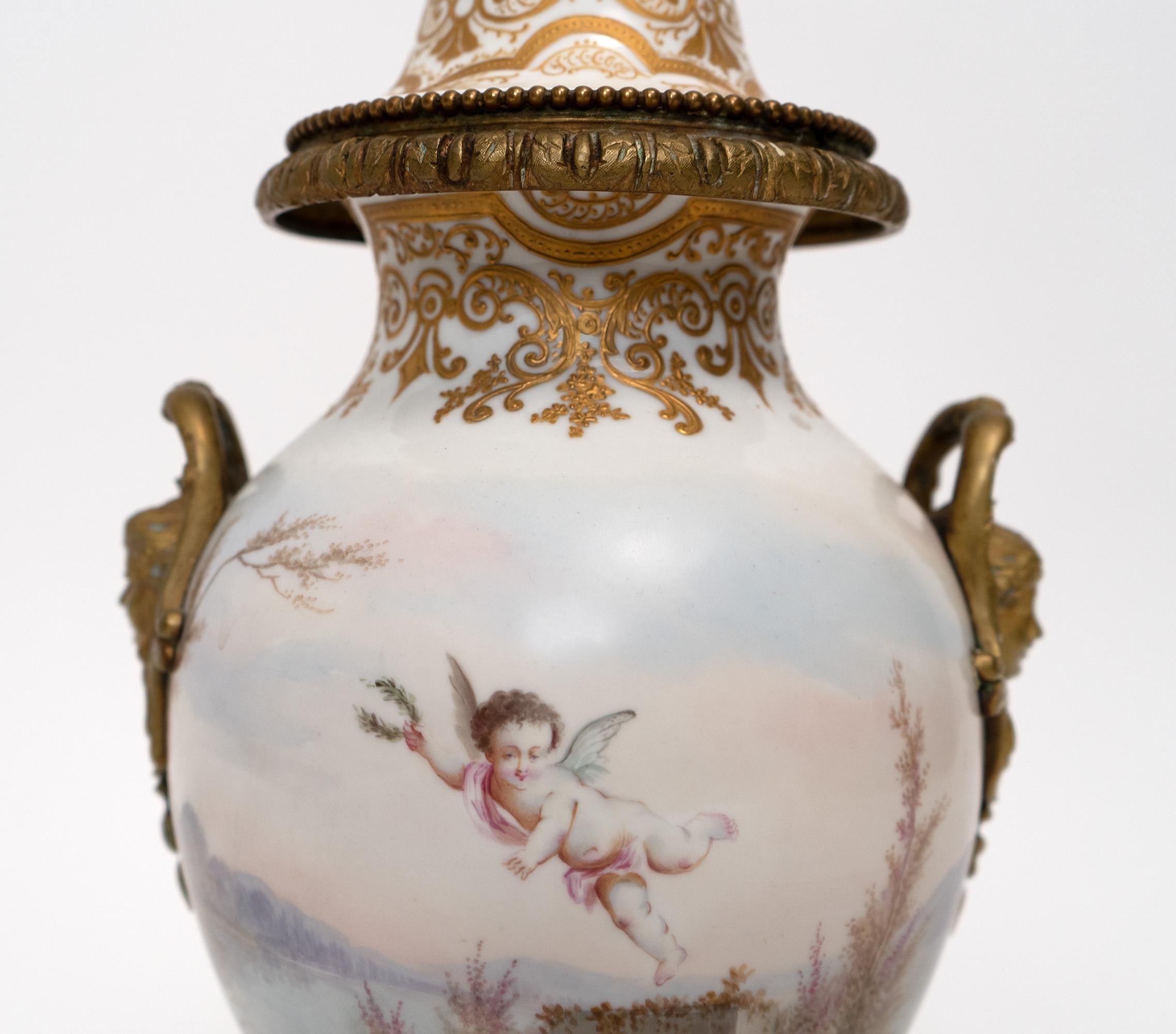 Front is painted with a scene of a woman and cherub and back with a flying cherub. 

19 x 10 x 10 in.