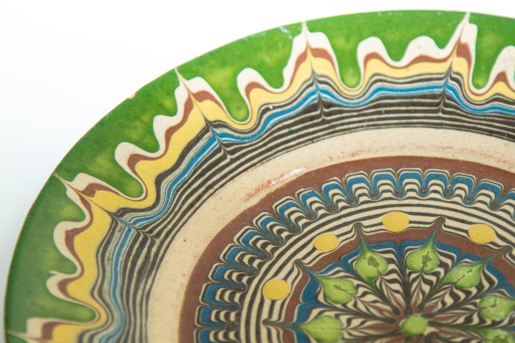 Vintage Romanian Ceramika hand-painted terra cotta pottery decorative plate.
Highly detailed marbleized pattern in shades of green, rust, yellow, ivory and dark brown.
Vintage Handmade ceramica de Horezu pottery plate, Romanian Folk Art, Bascu