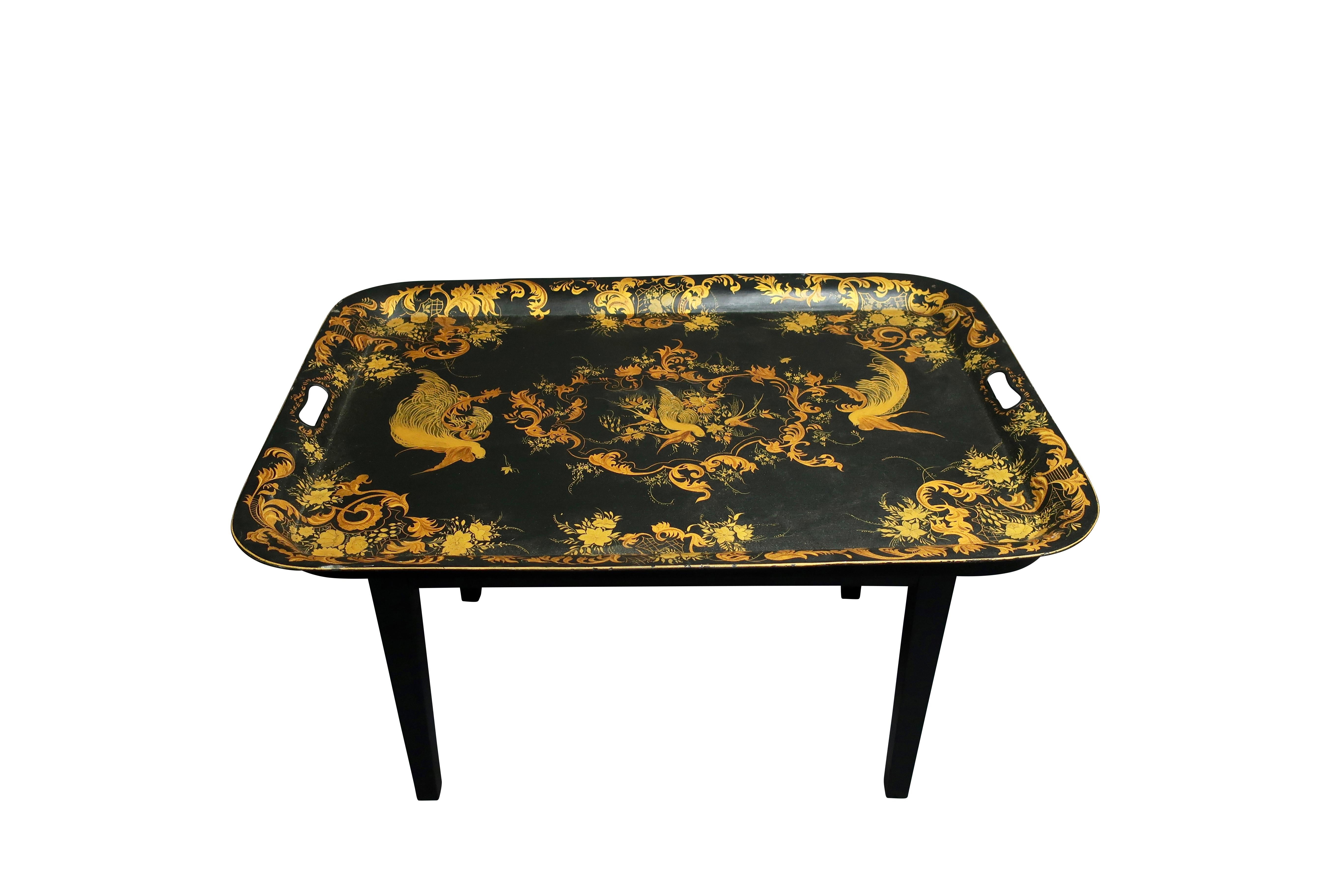 Hand painted tole tray coffee table in gold and black with bird decoration.