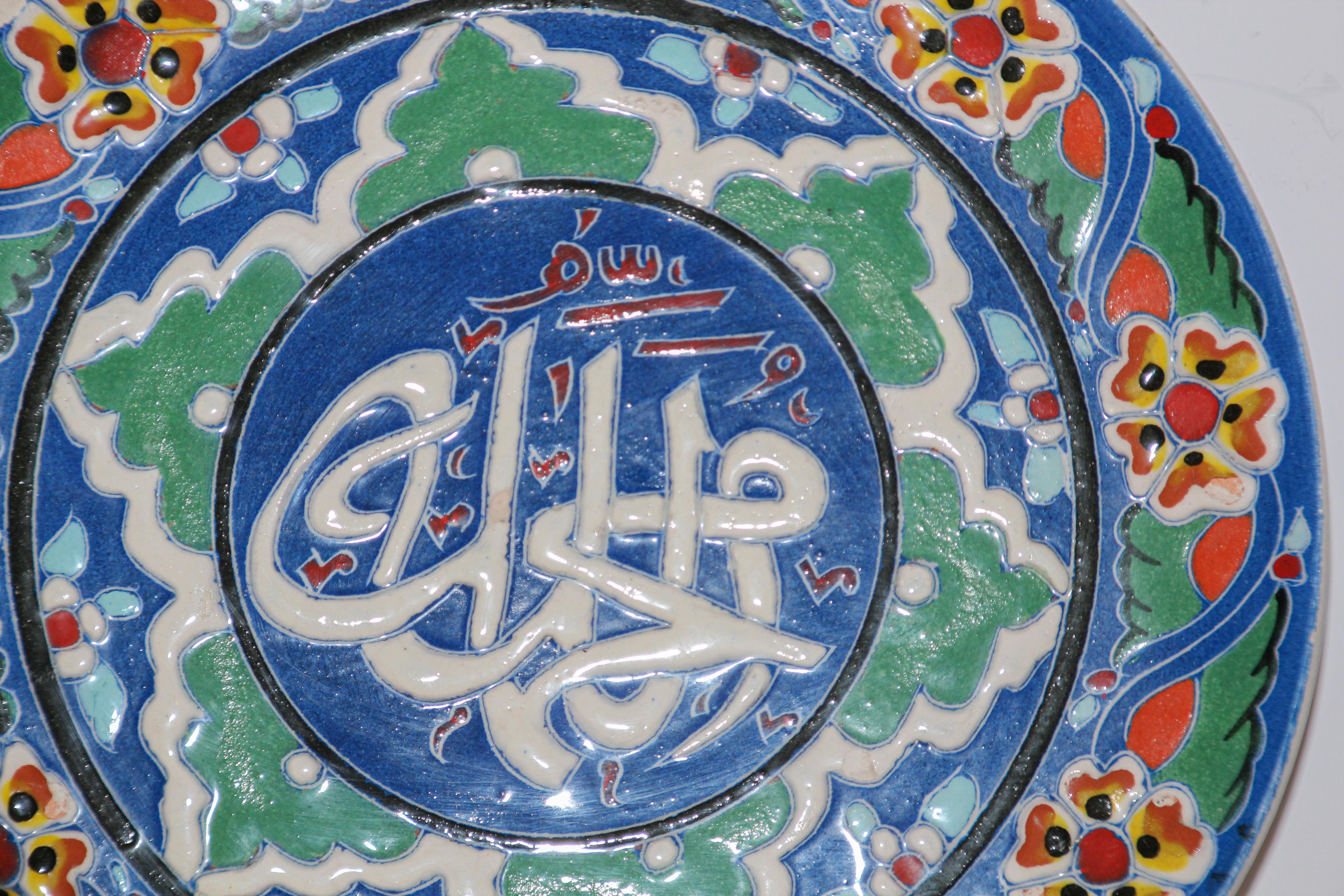 Hand painted and handcrafted Turkish ceramic wall decorative plate with polychrome ottoman floral design and Islamic calligraphy writing in the center.
This is an intricately, hand painted plate that was made in Turkey.
Turkey is famous for its kiln