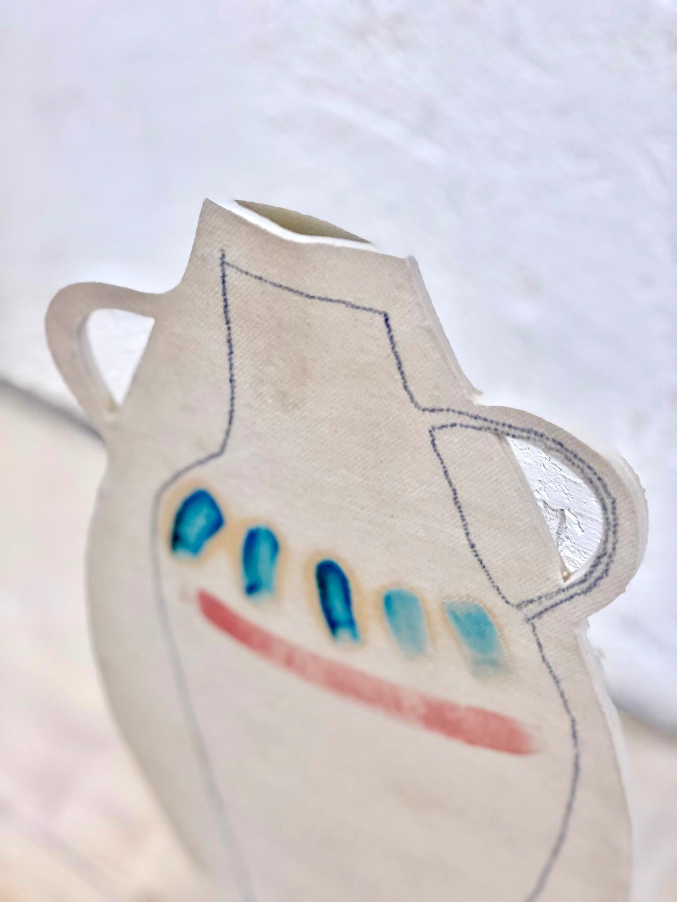 This hand painted double handled flat vase by Alison Owen is made through Owen's skillful hand-building technique, utilizing thin slabs of white stoneware clay, hand painted on the outside with glaze, and hand-drawn with underglaze pencil, with a