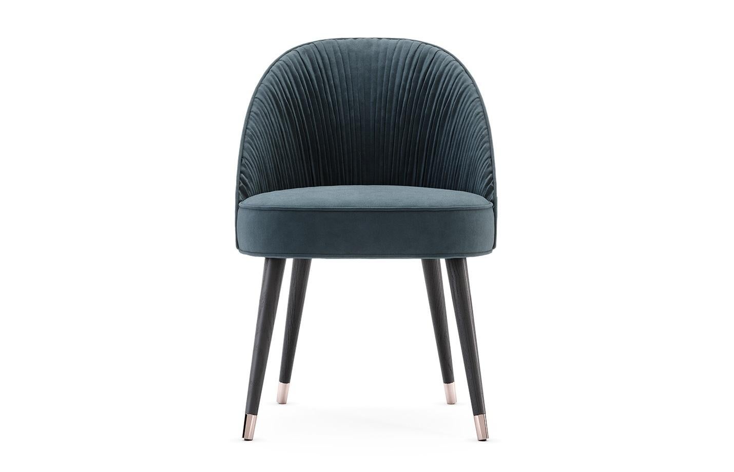 The contemporary dining chair hold a stimulating design, as they hold an elegant combination of handmade couture techniques, wood, and metal. Their shapes are inspired by the unique French couture and each detail will elegantly flow inside of an