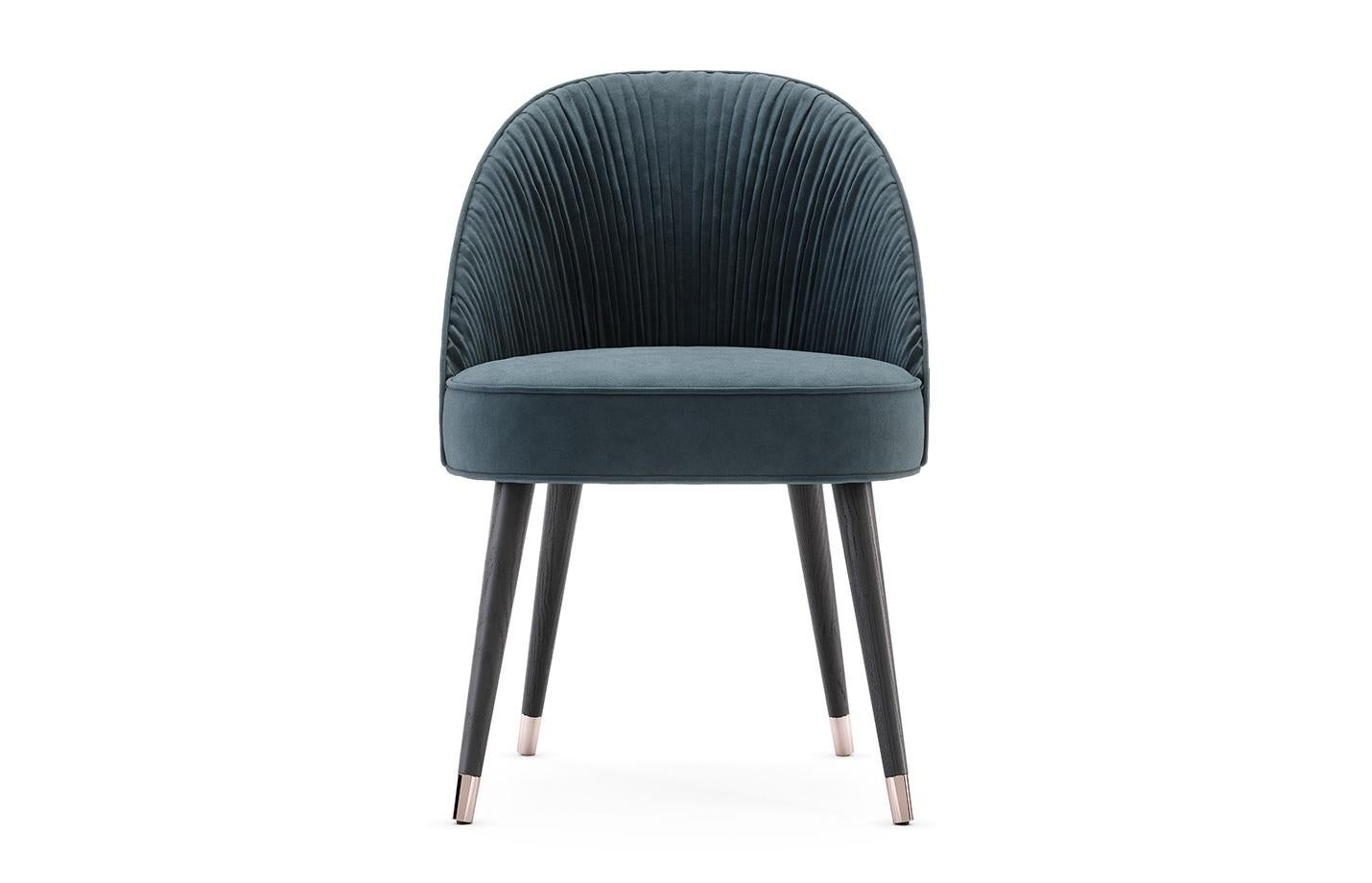 The contemporary dining chair hold a stimulating design, as they hold an elegant combination of handmade couture techniques, wood, and metal. Their shapes are inspired by the unique French couture and each detail will elegantly flow inside of an
