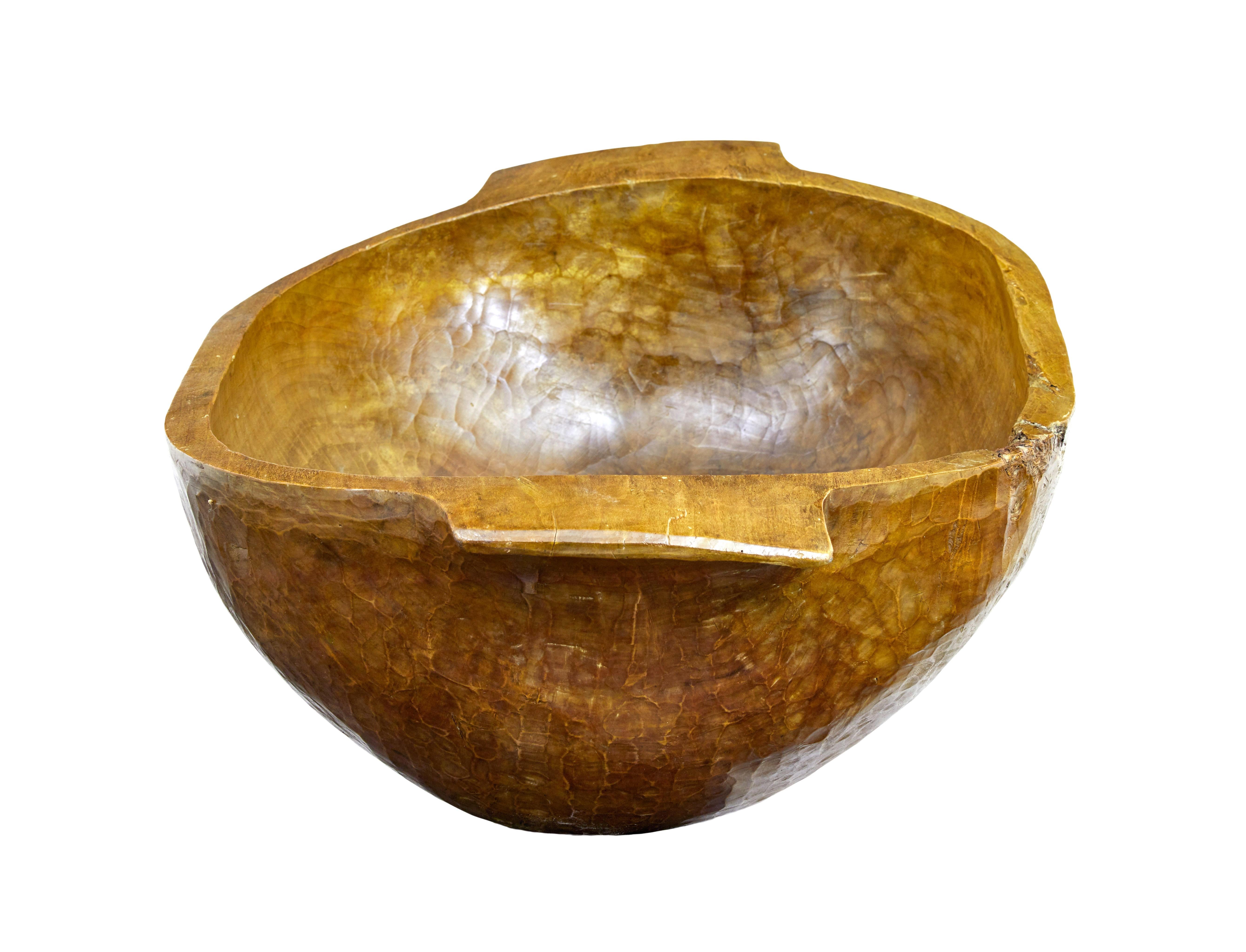 Hand polished large early 20th century carved bowl circa 1900.

Handmade from carving from a solid tree trunk. These were made in eastern Europe as a way of feeding livestock. Due to the condition of this example there's no evidence it got used