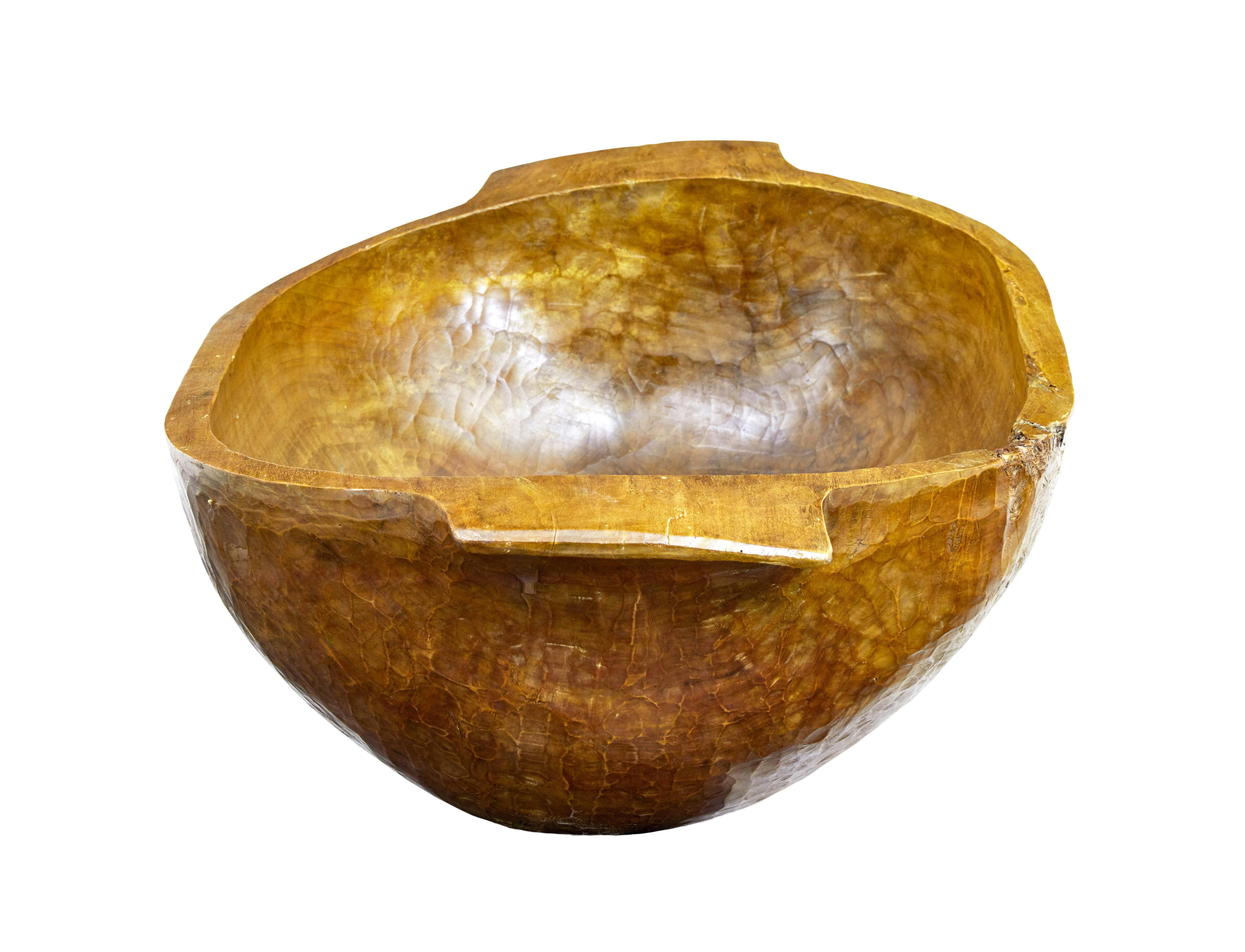 Hand polished large early 20th century carved bowl circa 1900.

Handmade from carving from a solid tree trunk.  These were made in eastern europe as a way of feeding livestock.  Due to the condition of this example there's no evidence it got used